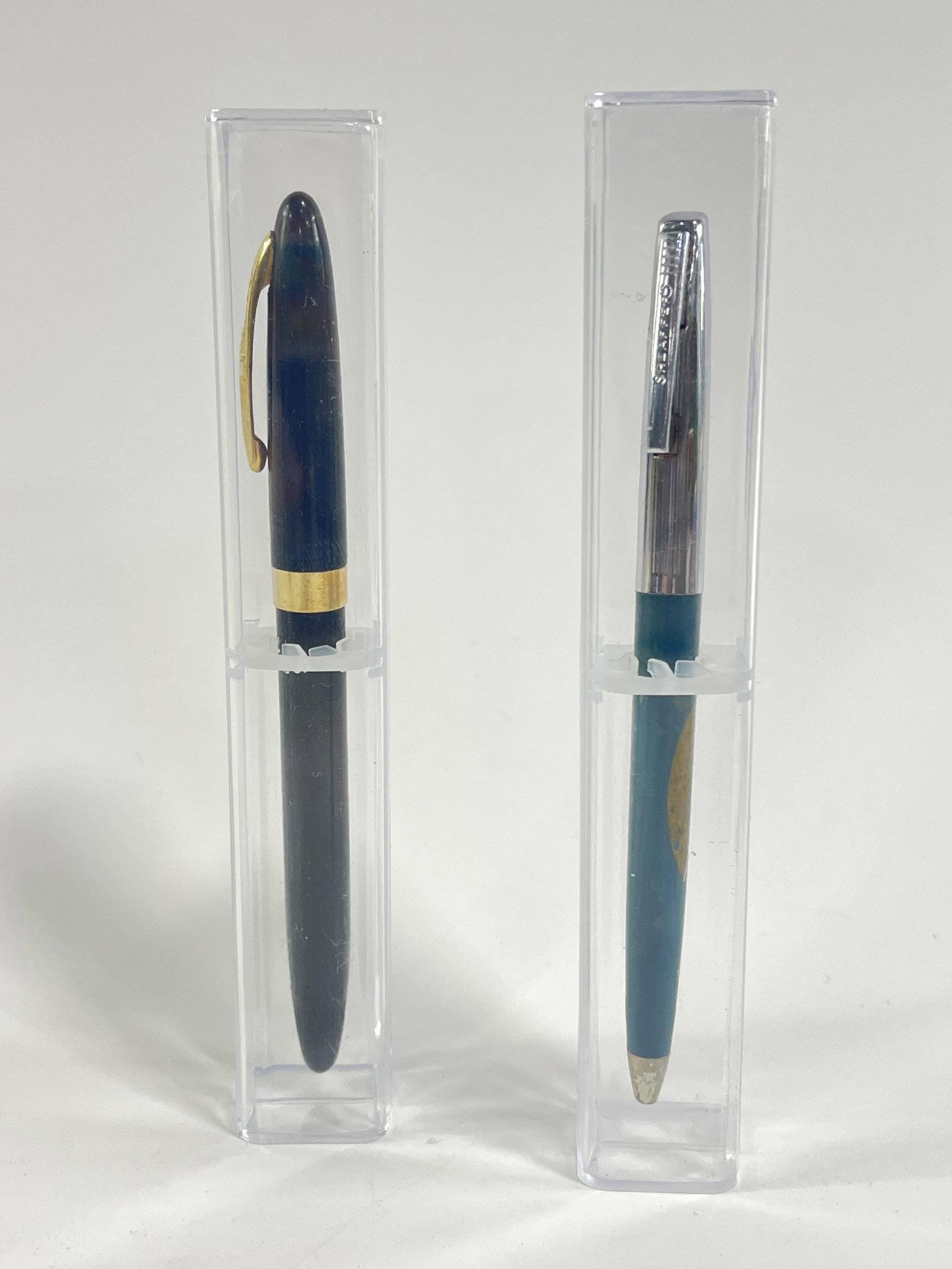 Pair of Sheaffers pens: Pair of Sheaffers pens Saigon Vietnam pen with Saigon girl Sheaffer black pen with gold accents and 14k nib both in plastic cases
