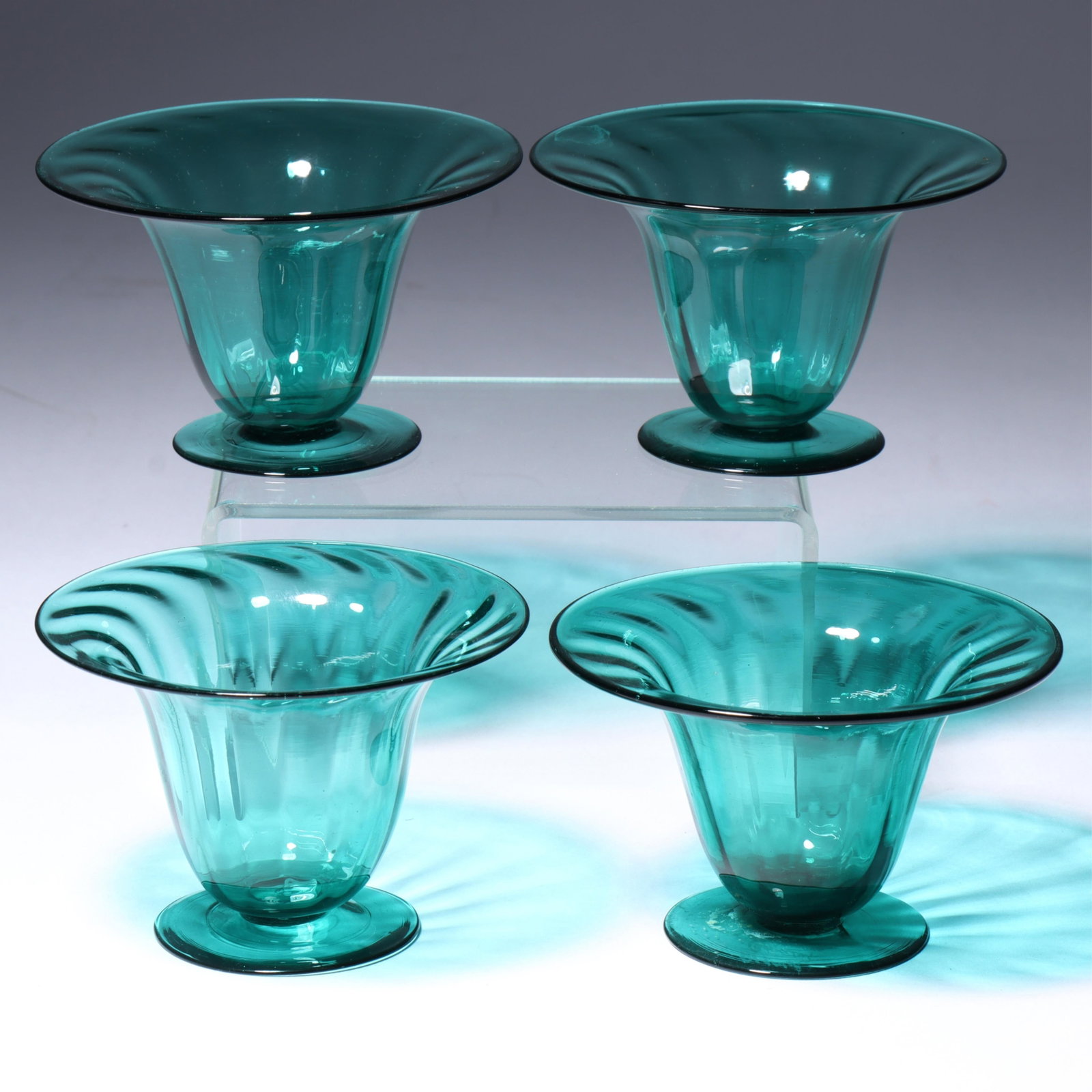 Four Maestri Vetrai Muranesi (MVM) Murano Cappellin tulip shaped bowls in dark teal 2 1/4"H x 3: Four Maestri Vetrai Muranesi (MVM) Murano Cappellin tulip shaped bowls in dark teal Acid stamps present on all. Provenance: Fort Wayne Museum of Art, Fort Wayne, Indiana. 2 1/4"H x 3 1/4"Diam. (one)