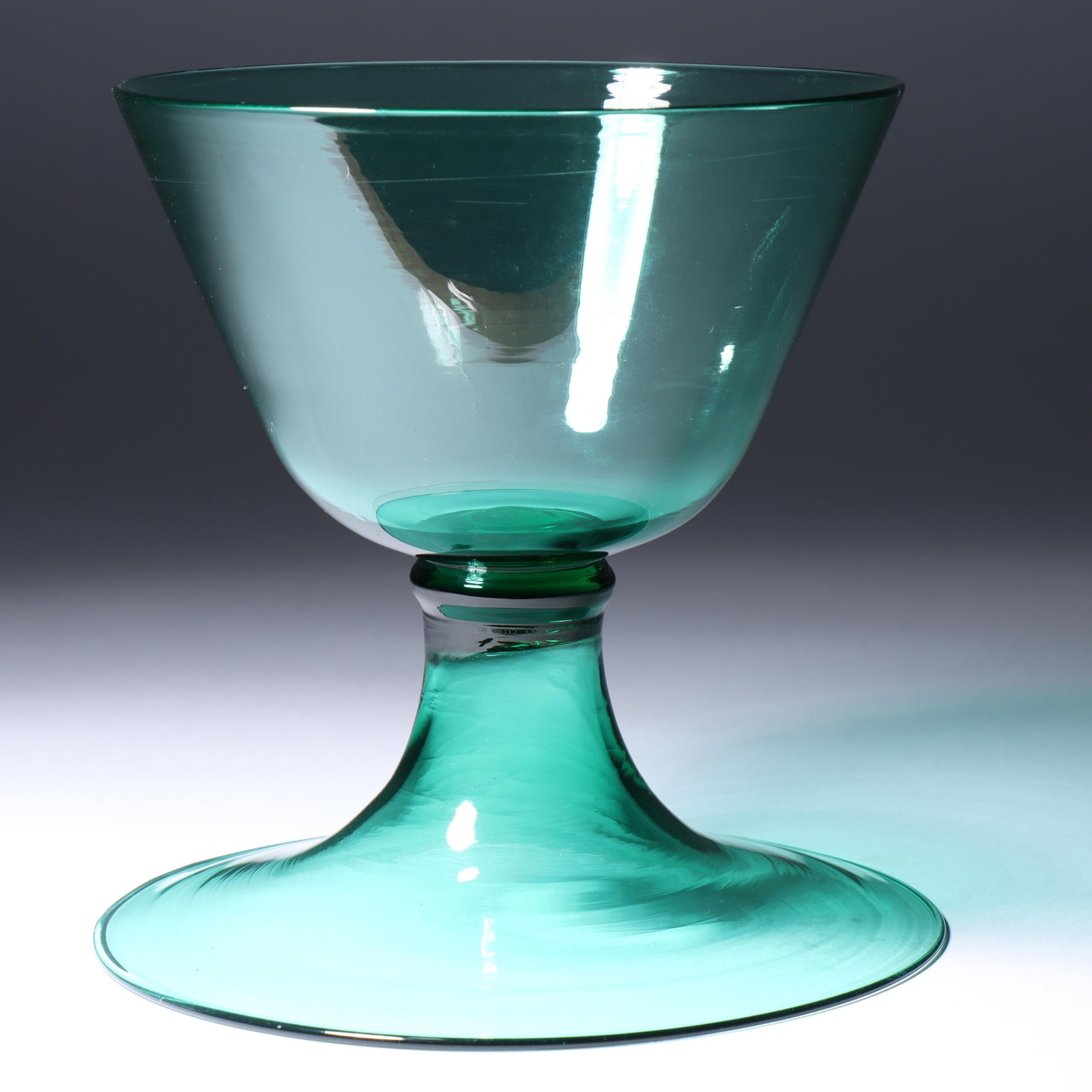 Maestri Vetrai Muranesi (MVM) Murano Cappellin ca. 1925 stemmed bowl/vase with domed foot, knop and: Maestri Vetrai Muranesi (MVM) Murano Cappellin ca. 1925 stemmed bowl/vase with domed foot, knop and straight sided in dark green Unmarked. Provenance: Fort Wayne Museum of Art, Fort Wayne, Indiana. 6"