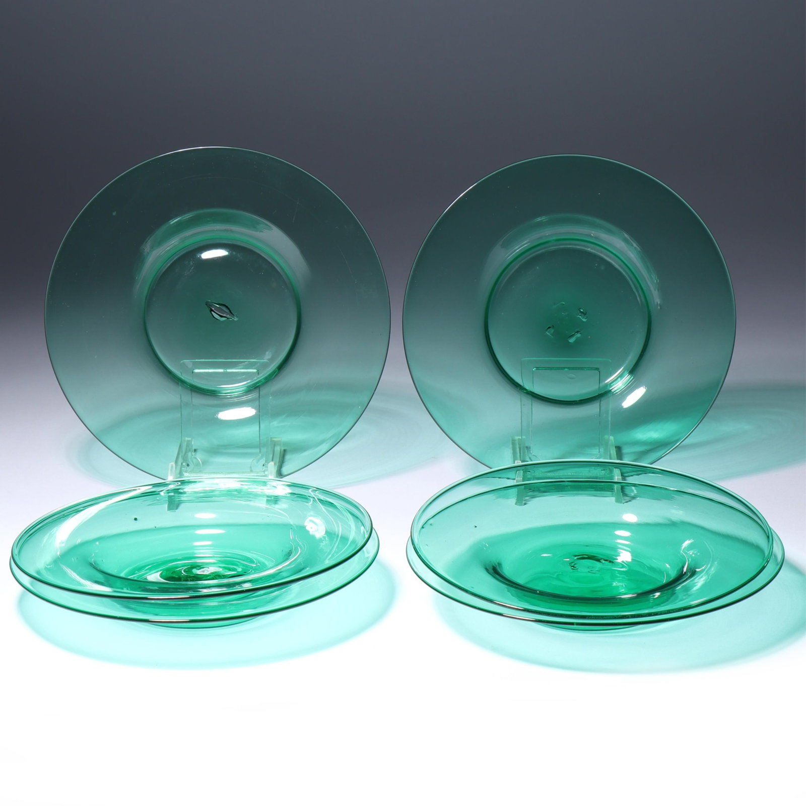 Six Maestri Vetrai Muranesi (MVM) Murano Cappellin ca. 1925 side plates with deep center in dark: Six Maestri Vetrai Muranesi (MVM) Murano Cappellin ca. 1925 side plates with deep center in dark green/teal Unmarked. Provenance: Fort Wayne Museum of Art, Fort Wayne, Indiana. 1"H x 6"Diam. (one)