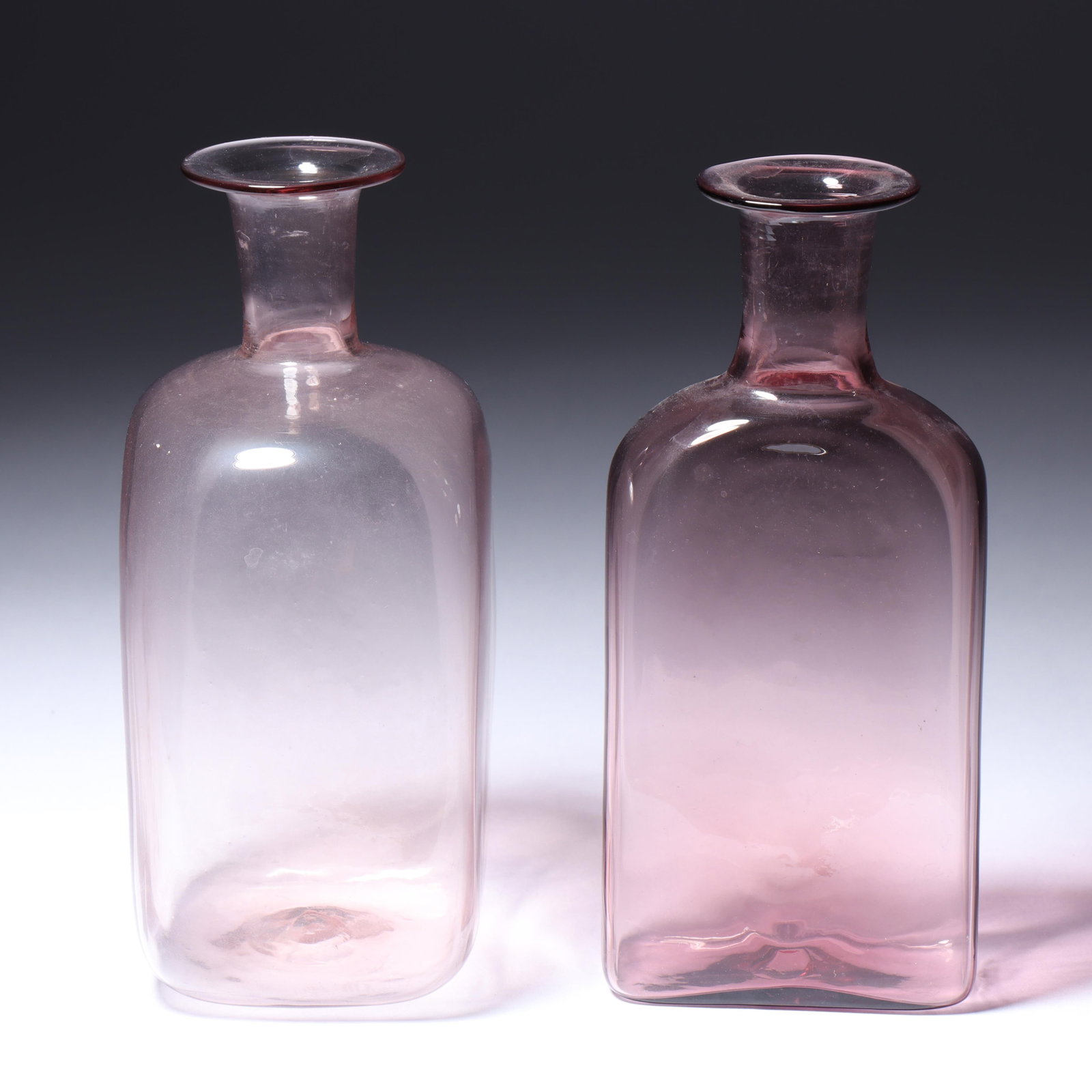 Two Maestri Vetrai Muranesi (MVM) Murano Cappellin ca. 1925 scent bottles without stoppers in purple: Two Maestri Vetrai Muranesi (MVM) Murano Cappellin ca. 1925 scent bottles without stoppers in purple and pale pink One features acid stamp to bottom and one is unmarked. Provenance: Fort Wayne Museum 
