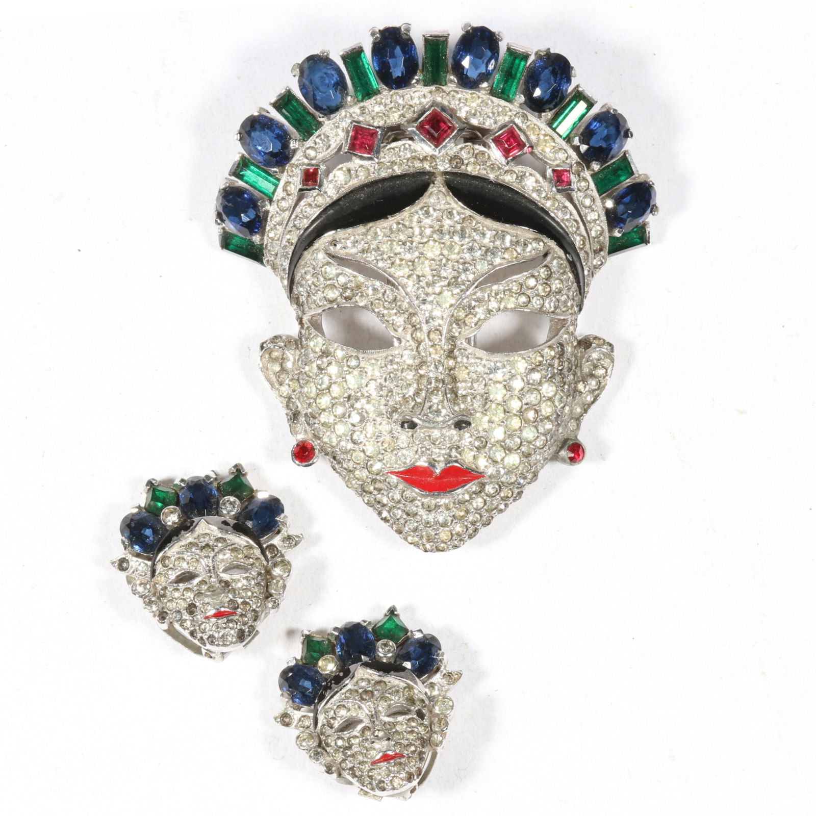 Mazer "Oriental Mask" 1940's retro rhodium plated book piece fur clip and matching earrings with: Mazer "Oriental Mask" 1940's retro rhodium plated book piece fur clip and matching earrings with rhinestone pave, green, blue, and red stones, black and red enamel. From the inventory of the former vi