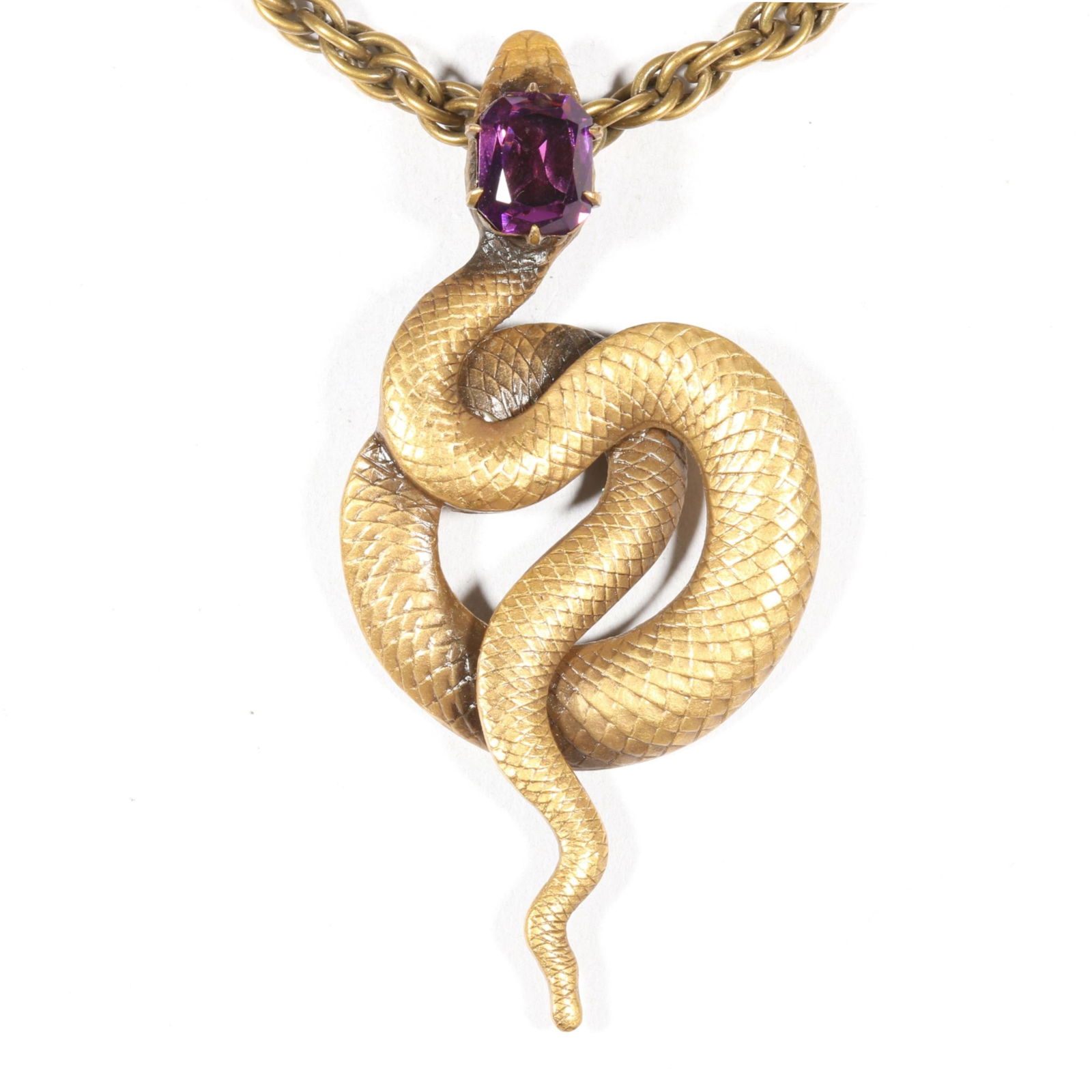 Joseff of Hollywood gilt coiled snake pendant necklace with large violet jewel. 24"L x 2 7/8"Drop: Joseff of Hollywood gilt coiled snake pendant necklace with large violet jewel. From the inventory of the former vintage costume jewelry business, "Aunt Tink", "seller of the collectible, the fun and