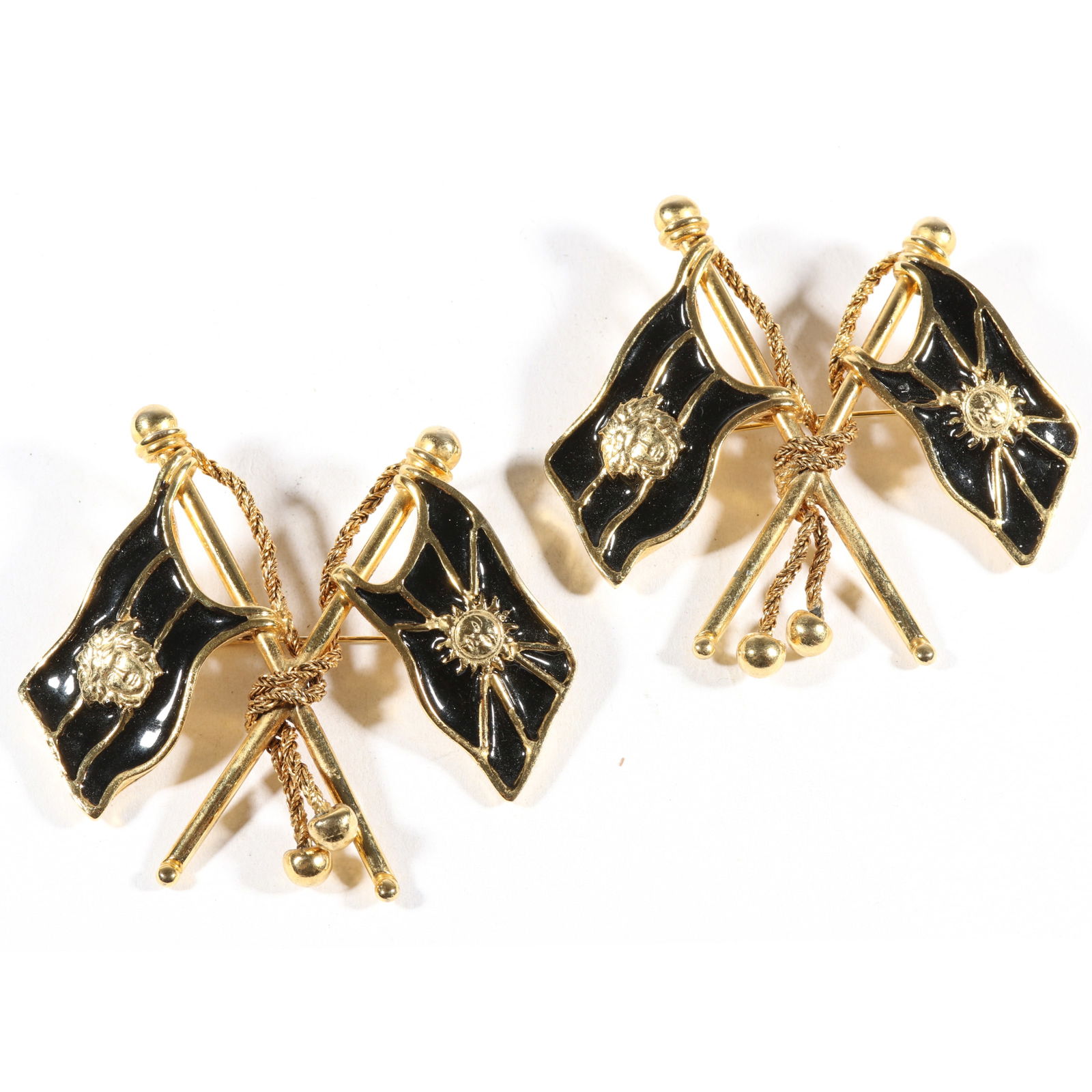 Pair of Gianni Versace designer couture black enamel flag brooches, Autumn/Winter 1992-1993, 2 5/8"H: Pair of Gianni Versace designer couture black enamel flag brooches, Autumn/Winter 1992-1993 Design featured in the Fall 1992 ad campaign. Unstamped and attributed to: Gianni Versace. 2 5/8"H x 3"W (bo