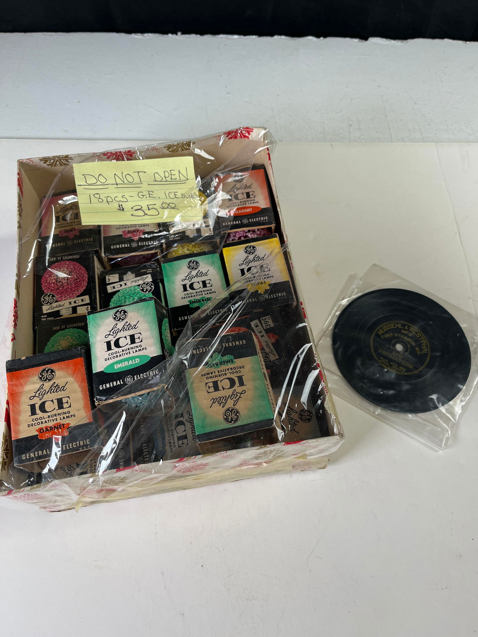 Box of vintage General Electric Lighted Ice Christmas light bulbs from 1960s and 70s untested AND a: Box of vintage General Electric Lighted Ice Christmas light bulbs from 1960s and 70s untested AND a vintage record saw demo which was likely included as part of a musical saw kit