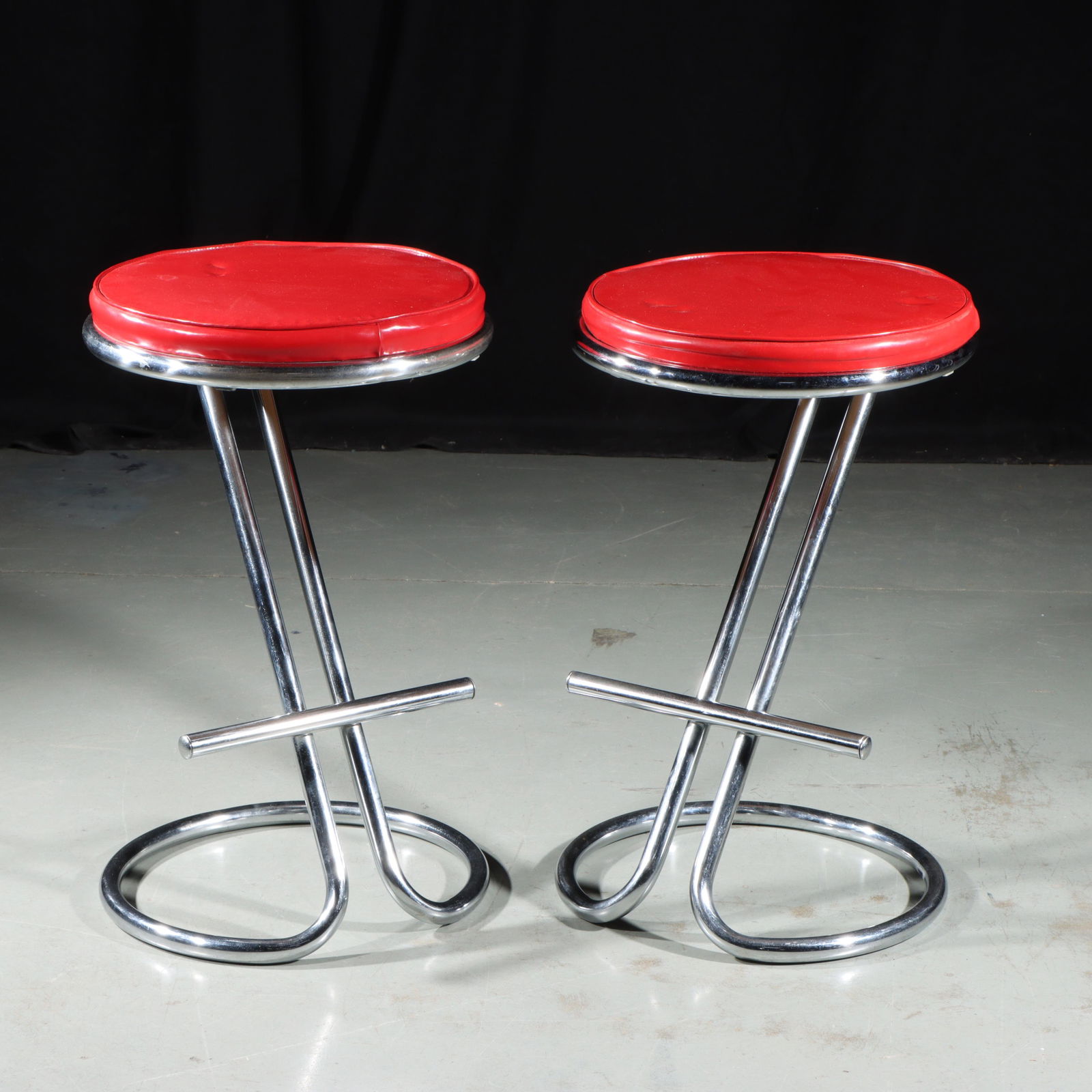 Machine Age Gilbert Rohde Z Chrome Stools w/foot rests, Pair 24"H x 14"Diam: Machine Age Gilbert Rohde Z Chrome Stools w/foot rests. Pair Designed by Gilbert Rohde, this later iteration added the foot rest to the iconic Z shape for additional comfort. Provenance Charles Alexan
