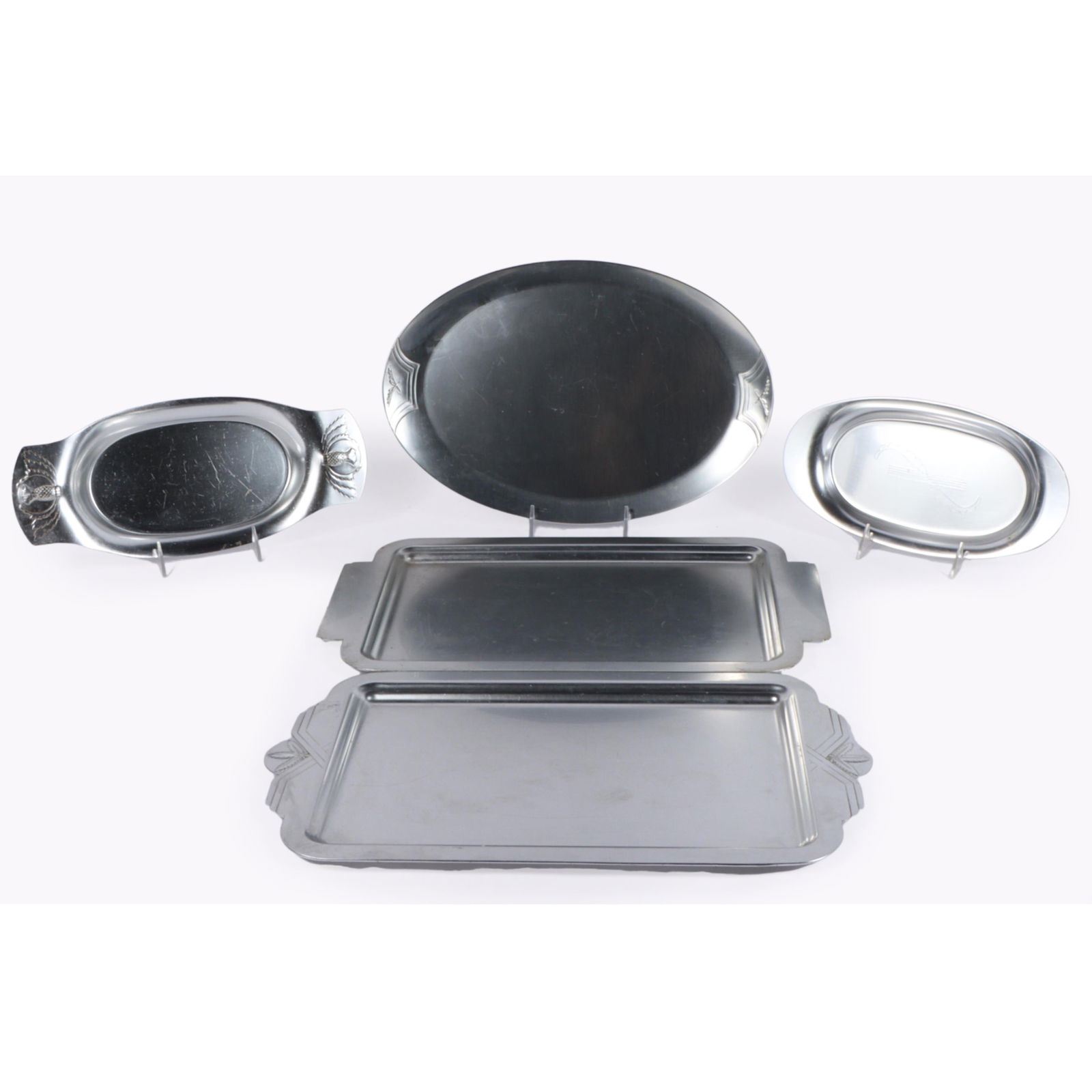Five Lurelle Guild Kensington Aluminum Trays 10 1/2"H x 10 1/2"W (Largest): Five Lurelle Guild Kensington Aluminum Trays #7157 "Chelsea" serving tray; #7332 "Hampton" oval platter (retail $7.50) w/repousse decoration at both ends, patented 1940; oval "Clifton" dish, 1939; ova