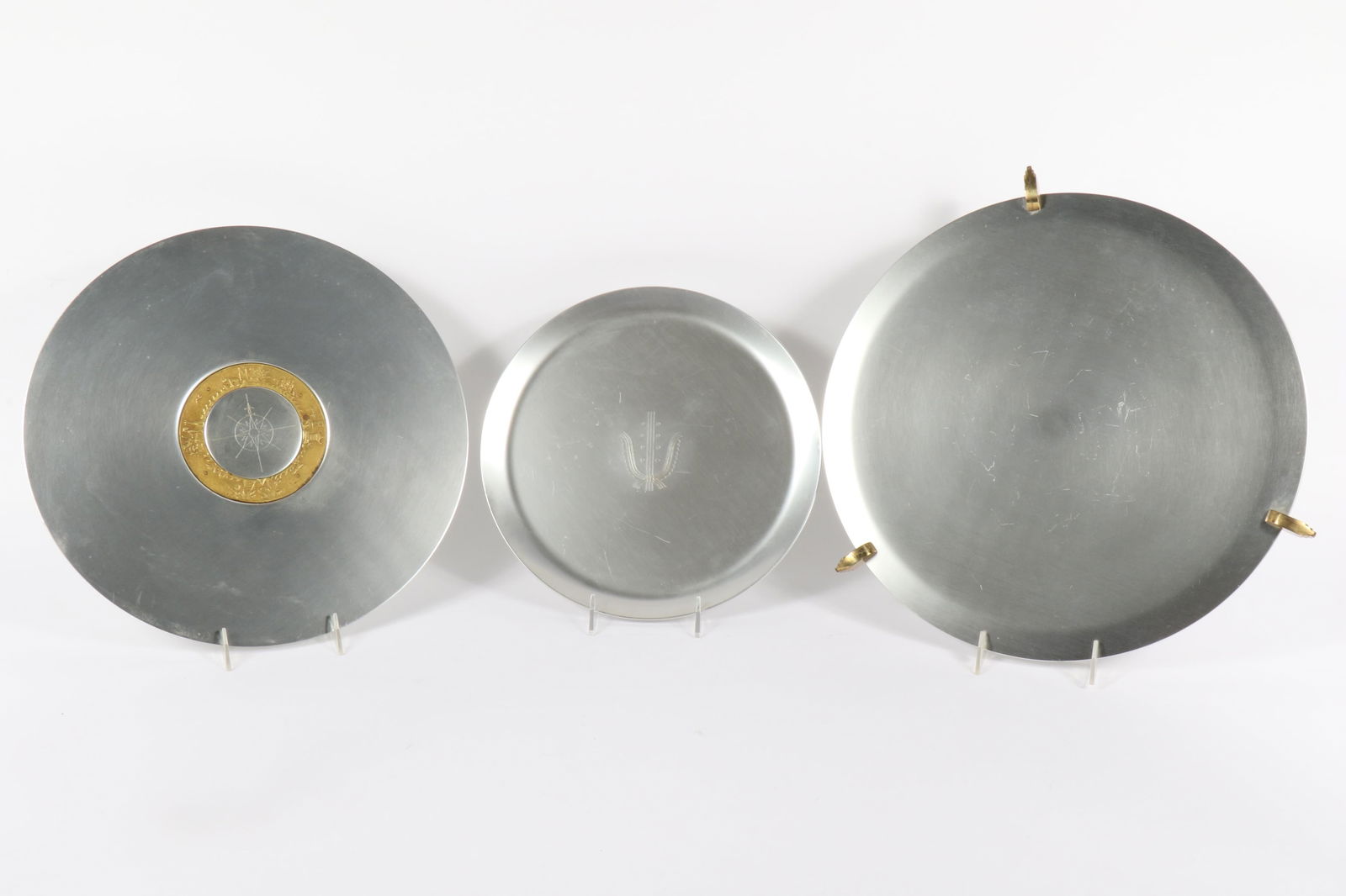 Kensington Lurelle Guild 3 Aluminum Trays 16" Diam. (Largest): Kensington Lurelle Guild 3 Aluminum Trays #7105-16" Round "Aztec" or "Cortez" Footed Platter; #7102 15" "Compass" Platter (retail price $7.50) designed in 1935; #7159 12 1/4" "Savoy" Round Tray (retai