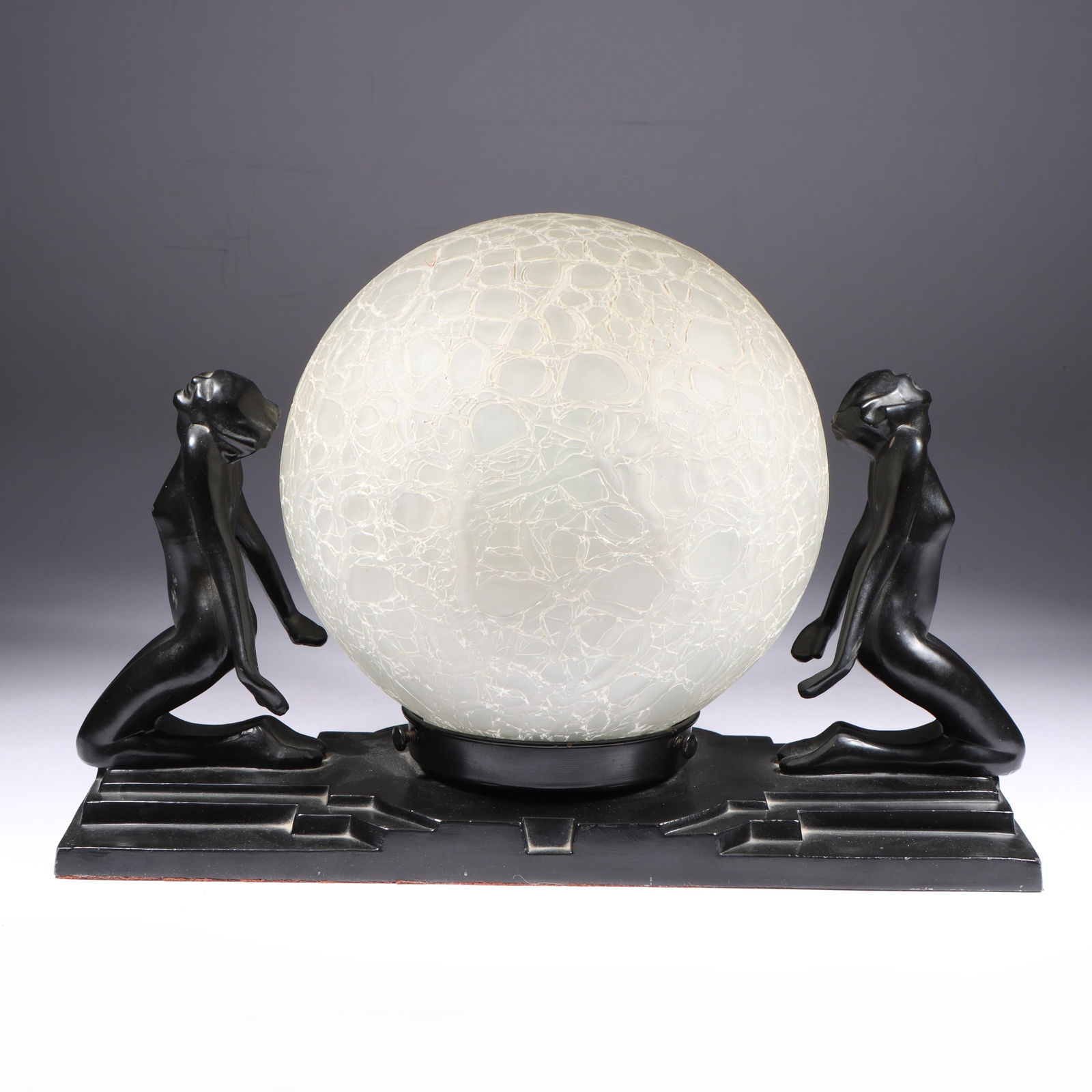 Frankart Art Deco double nude Lamp 9"H x 14"W: Frankart Art Deco double nude Lamp having two black enamel female flanking forms backing a clear frosted orb brain shade. 9"H x 14"W