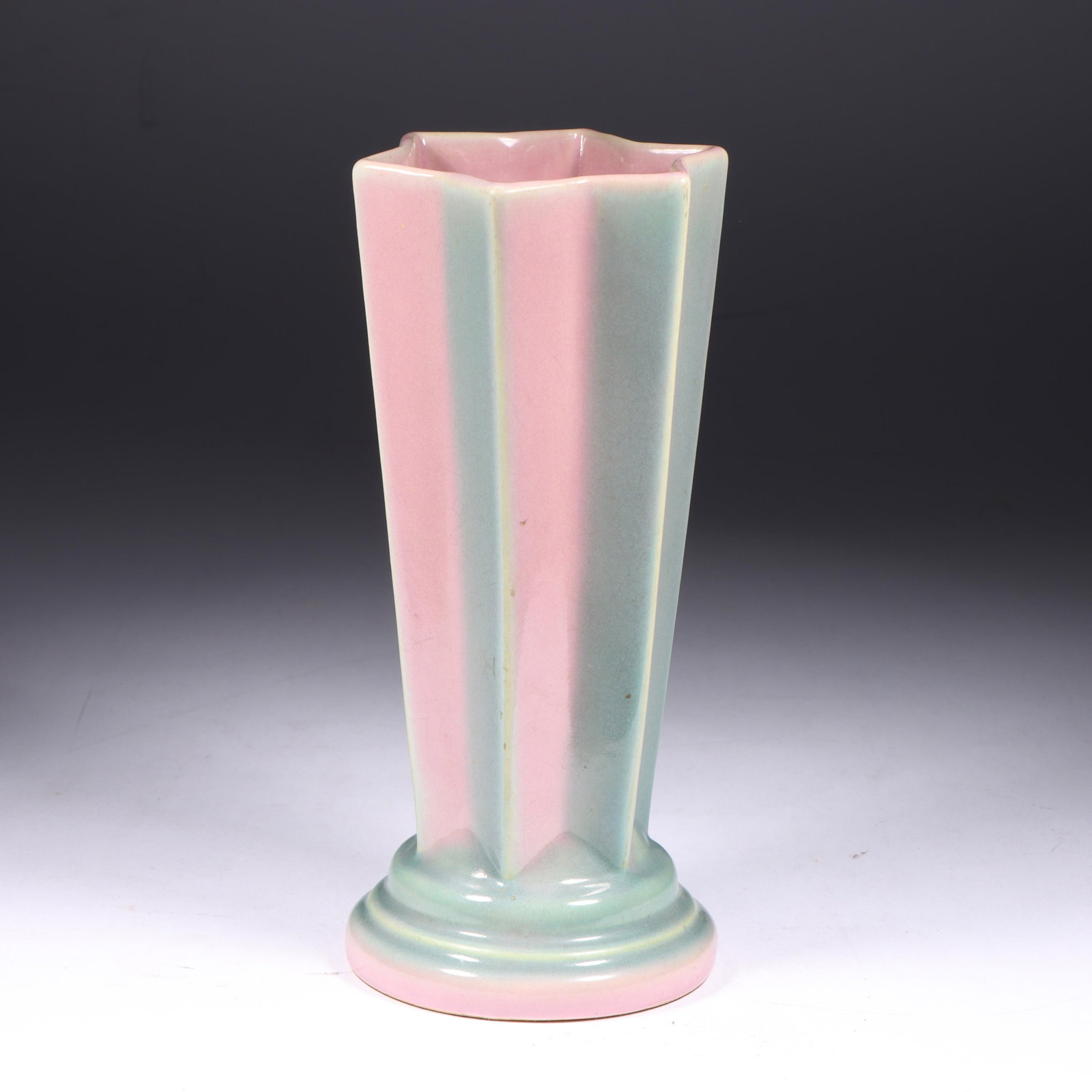 Roseville Futura Vase, 8 1/2?H x 3 3/4?Diam.: Roseville Futura Vase Shape #385; dubbed by collectors as "Pleated Star" pink & grey glossy glaze; unmarked. Provenance: Charles Alexander, Indianapolis, IN 8 1/2?H x 3 3/4?Diam.