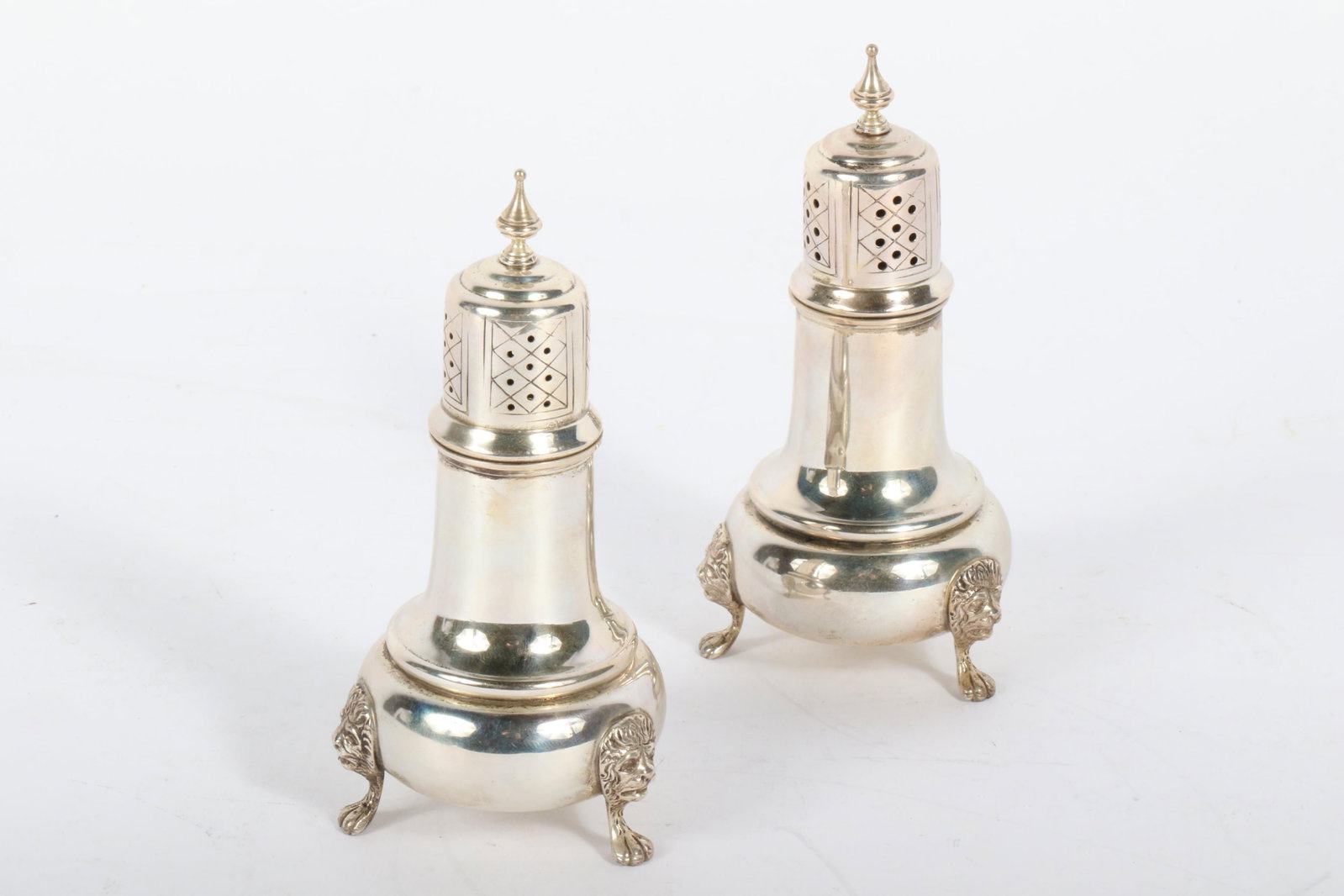 Amston sterling silver salt and pepper shakers, tableware with lion head paw feet. 5in tall, 2.5in: Amston sterling silver salt and pepper shakers, tableware with lion head paw feet. 5in tall, 2.5in wide A pair of sterling silver shakers by Amston, featuring a classic design with intricate detailing