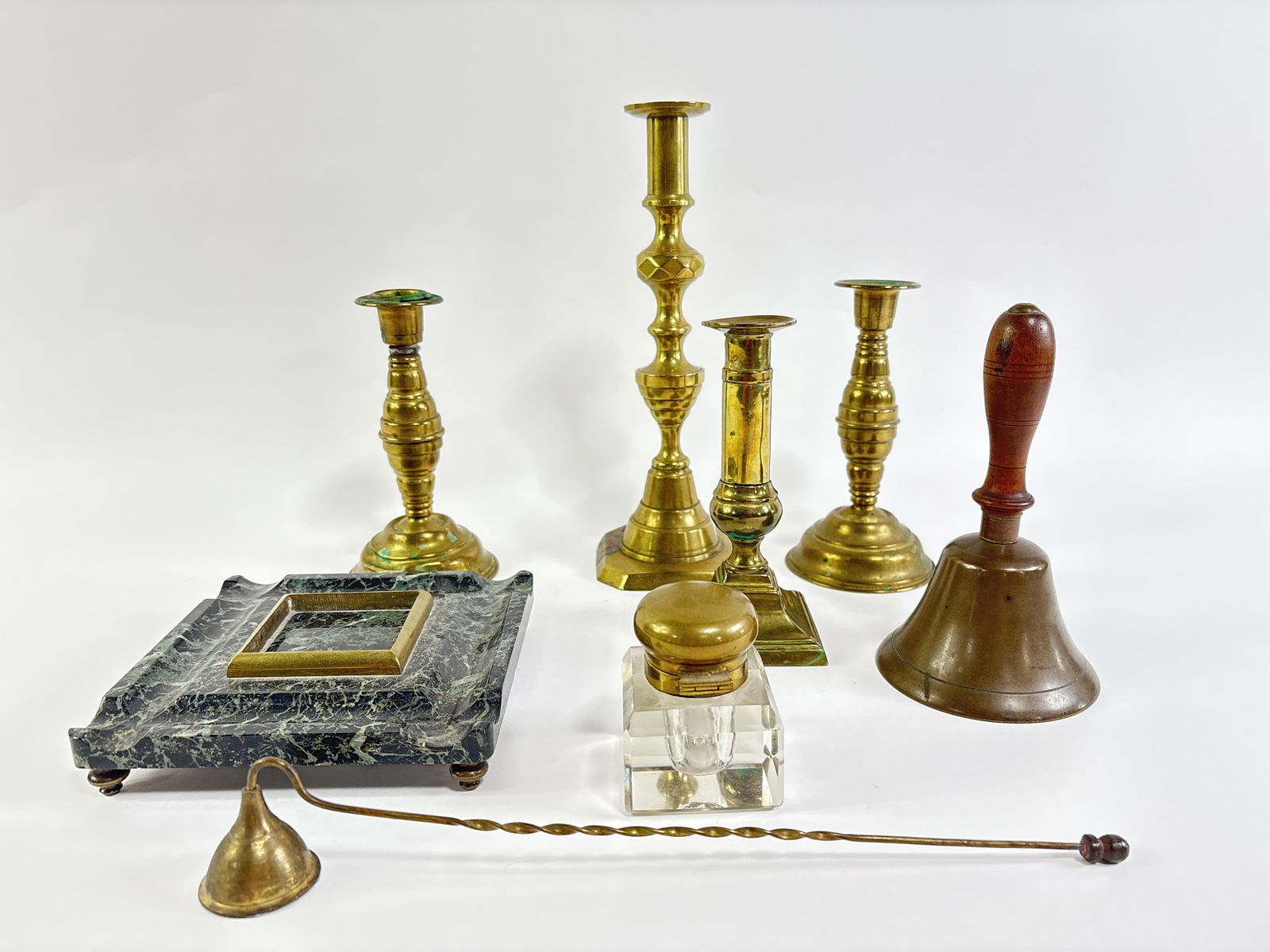 Vintage brass group, 7pc: four candlesticks, candle snuff, brass school bell with wooden handle,: Vintage brass group, 7pc: four candlesticks, candle snuff, brass school bell with wooden handle, glass inkwell with brass fittings and marble stand 9 1/2? H X 3 1/4? W X 3 1/4? D (tallest)