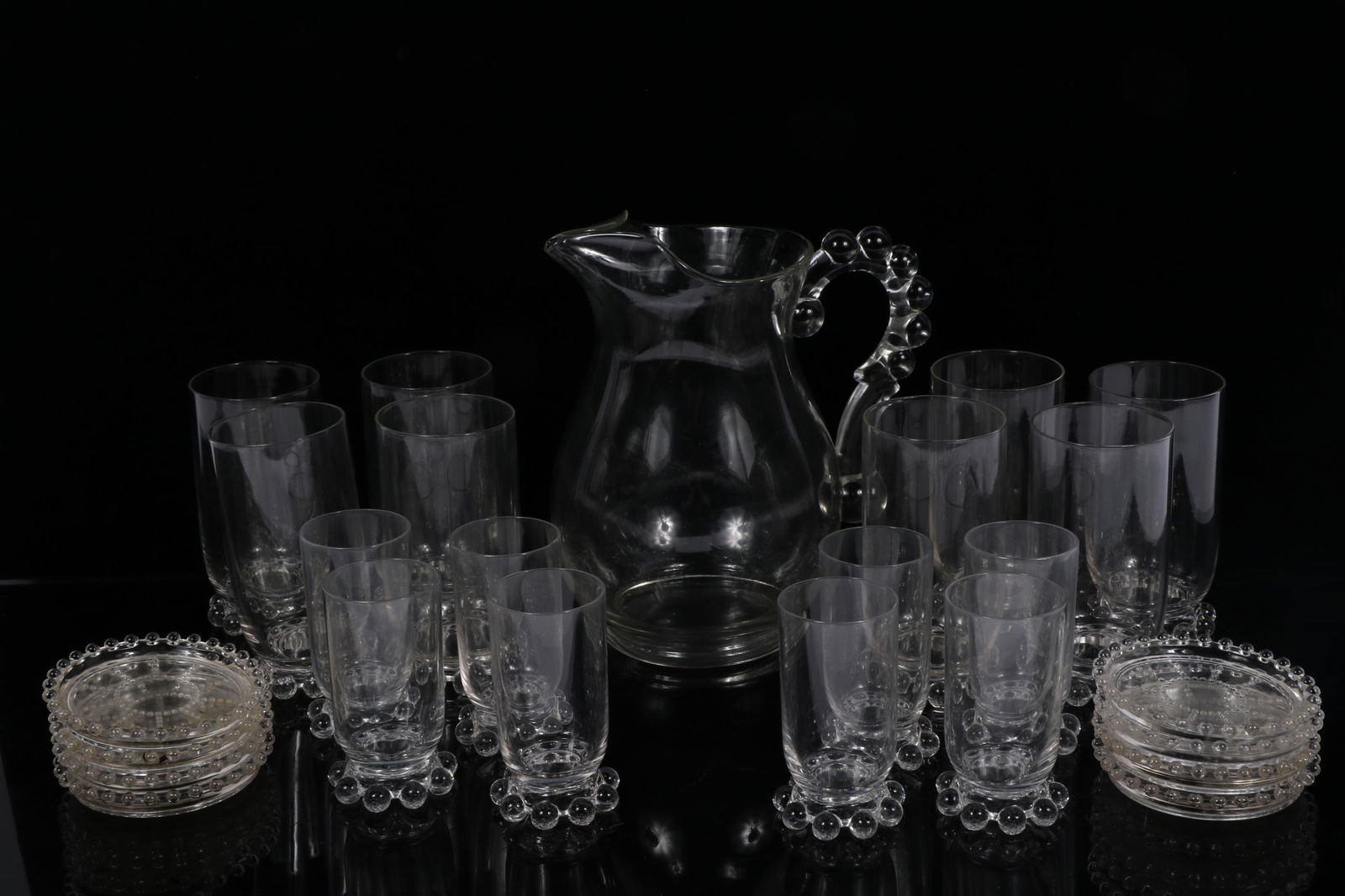 Collection of Imperial Glass Candlewick Clear glasswares, 25pc: 8 footed tumbler glasses, 8 juice: Collection of Imperial Glass Candlewick Clear glasswares, 25pc: 8 footed tumbler glasses, 8 juice glasses, 8 coasters, and pitcher 8 1/2"H x 5"DIA. (Pitcher)