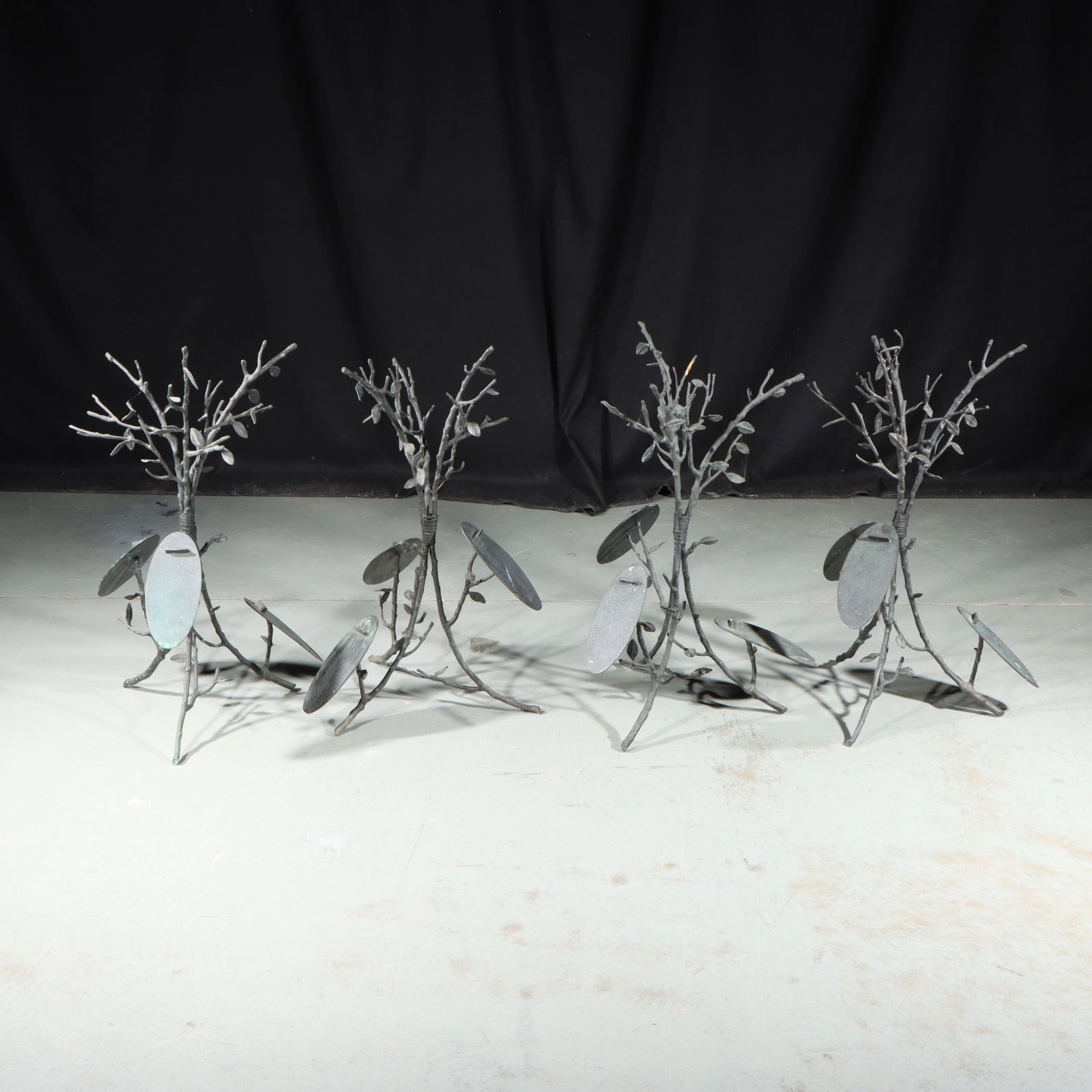 Four Michael Aram branch form bronze shoe store display stands for Saks Fifth Avenue 24 1/2"H x 15"W: Four Michael Aram branch form bronze shoe store display stands for Saks Fifth Avenue Incised signature on shoe platform. 24 1/2"H x 15"W (one)