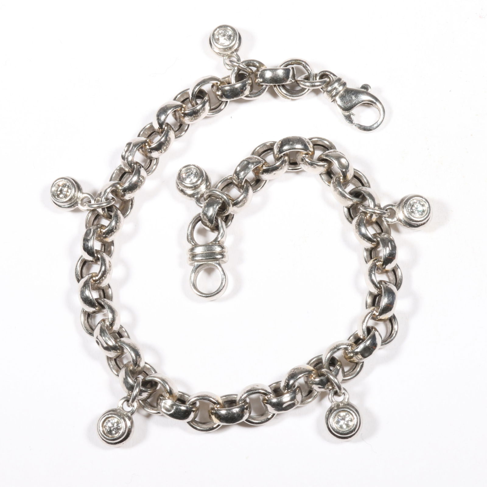 Scott Kay platinum chain link charm bracelet with 6 diamond charms 7" L x 1/2" W: Scott Kay platinum chain link charm bracelet with 6 diamond charms .60 total cttw 12.55 DWT The purchase of gold and platinum requires confirmed funds. From the collection of G. Thrapp Jewelers 7" L x