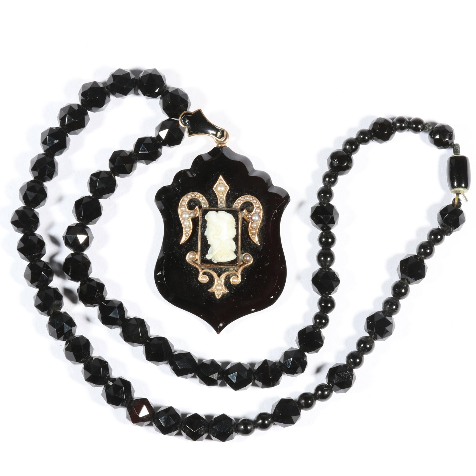 Victorian 14K yellow gold onyx shield cameo locket pendant with seed pearl accents on onyx beaded: Victorian 14K yellow gold onyx shield cameo locket pendant with seed pearl accents on onyx beaded necklace, unmarked tested Damage to enamel on bail. Back locket panel missing. Approx 16.50DWT (pendan