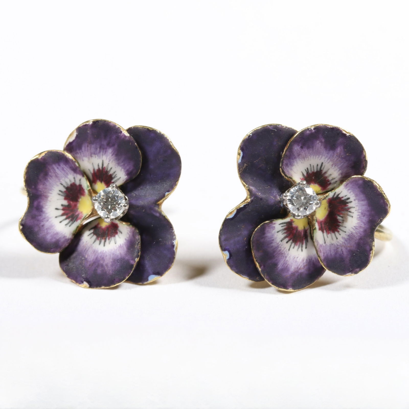 Antique 14K gold enamel violet or pansy floral earrings with diamond centers. 5/8"H x 5/8"W: Antique 14K gold enamel violet or pansy floral earrings with diamond centers. 4.822DWT The purchase of gold requires confirmed funds. From the collection of G. Thrapp Jewelers 5/8"H x 5/8"W