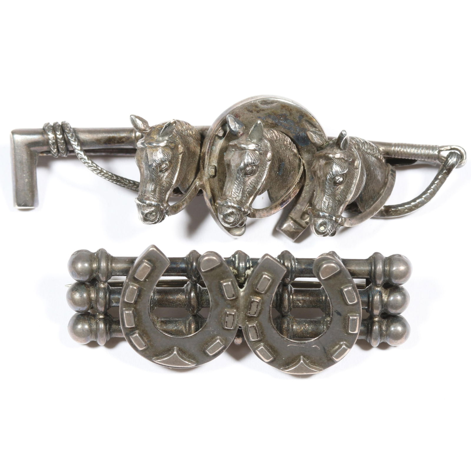 Pair of Victorian unmarked sterling? equestrian horse and horseshoe brooches. 2 3/8"L x 3/4"W: Pair of Victorian unmarked sterling? equestrian horse and horseshoe brooches. Provenance: From the collection of Sue Rudman, owner of Antique Source, Ltd in NYC for more than 45 years. 2 3/8"L x 3/4"W