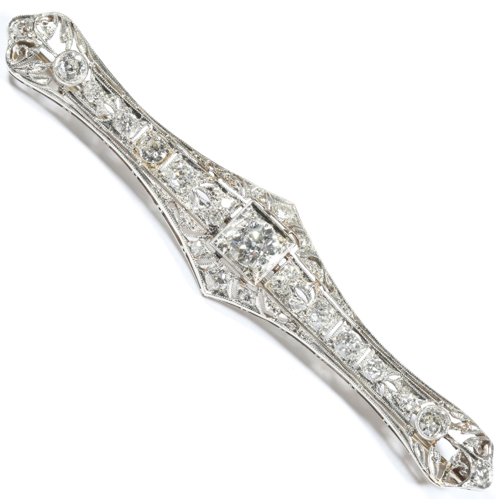 Art Deco platinum filigree diamond bar brooch with .58 carat Old European cut center diamond and 22: Art Deco platinum filigree diamond bar brooch with .58 carat Old European cut center diamond and 22 single cut diamonds weighing approx. 1.5 cttw 5.40 DWT Total estimated cttw is 2.08 Center stone: J,