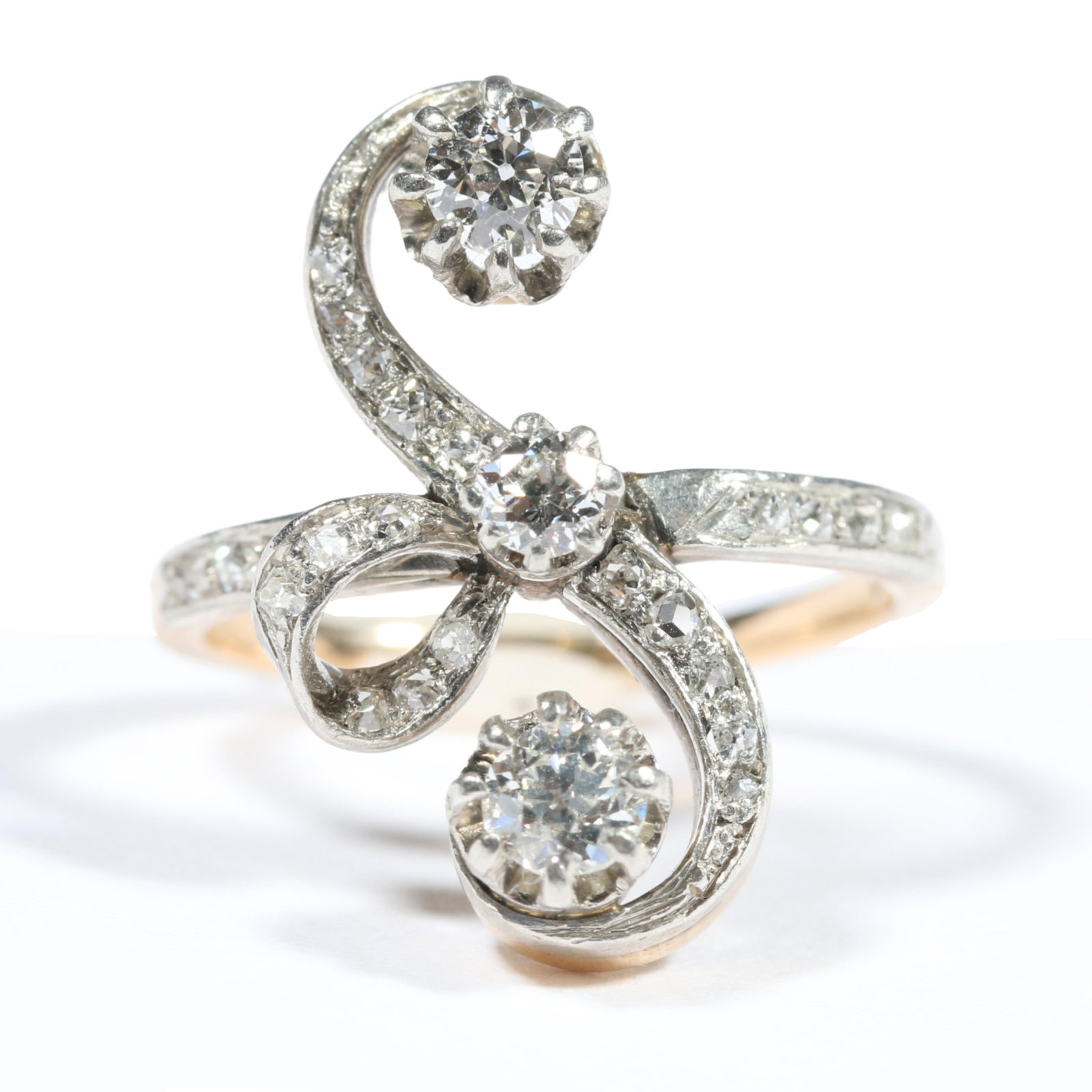 Antique Belle Epoque 14K white and yellow gold scroll ring with 23 round brilliant and rose cut: Antique Belle Epoque 14K white and yellow gold scroll ring with 23 round brilliant and rose cut diamonds Middle diamond setting has been repaired. 2.428DWT Est. .55 total cttw H-J, VS2-SI2 The purchas