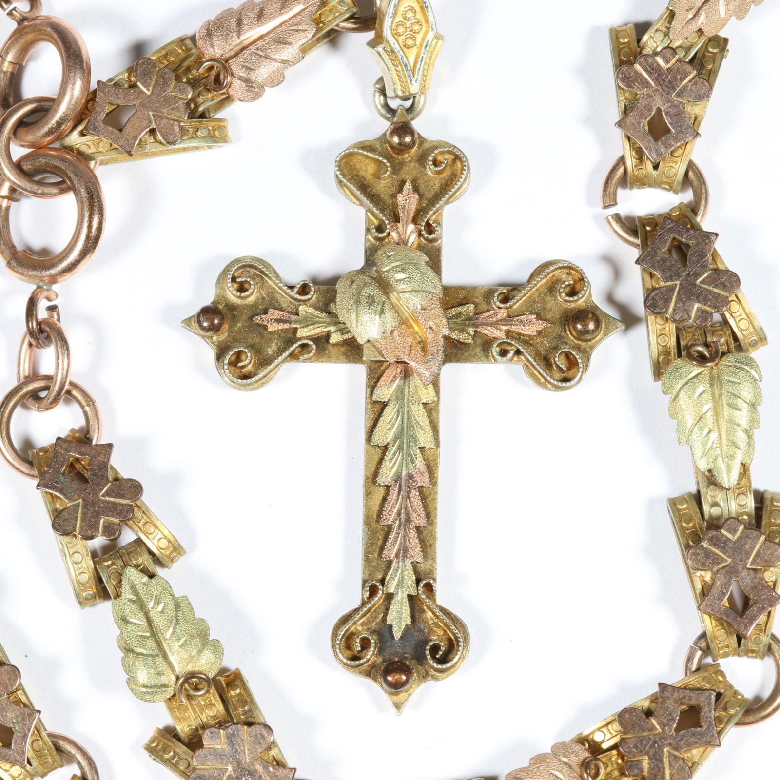Antique Victorian Etruscan Revival cross pendant suspended on matching ornate bookchain with leaf: Antique Victorian Etruscan Revival cross pendant suspended on matching ornate bookchain with leaf details. Light wear to gold fill. 18"L x 4 1/4"Drop