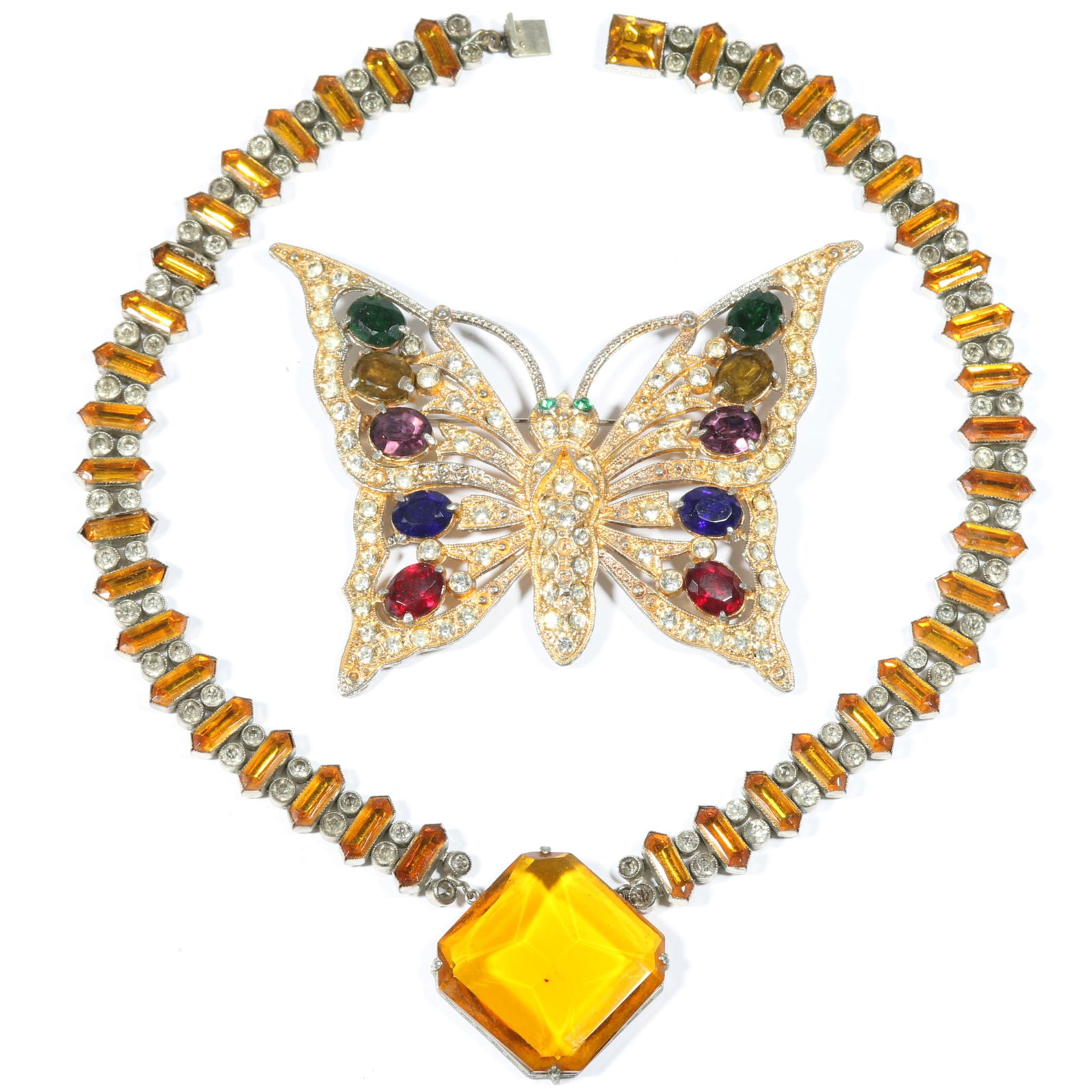 Deco Czech glass 2pc group with large jeweled butterfly brooch and amber colored necklace 17 1/2" L: Deco Czech glass 2pc group with large jeweled butterfly brooch and amber colored necklace Provenance: From the collection of Cheryl Killmer. 17 1/2" L x 1 3/4" W (necklace)