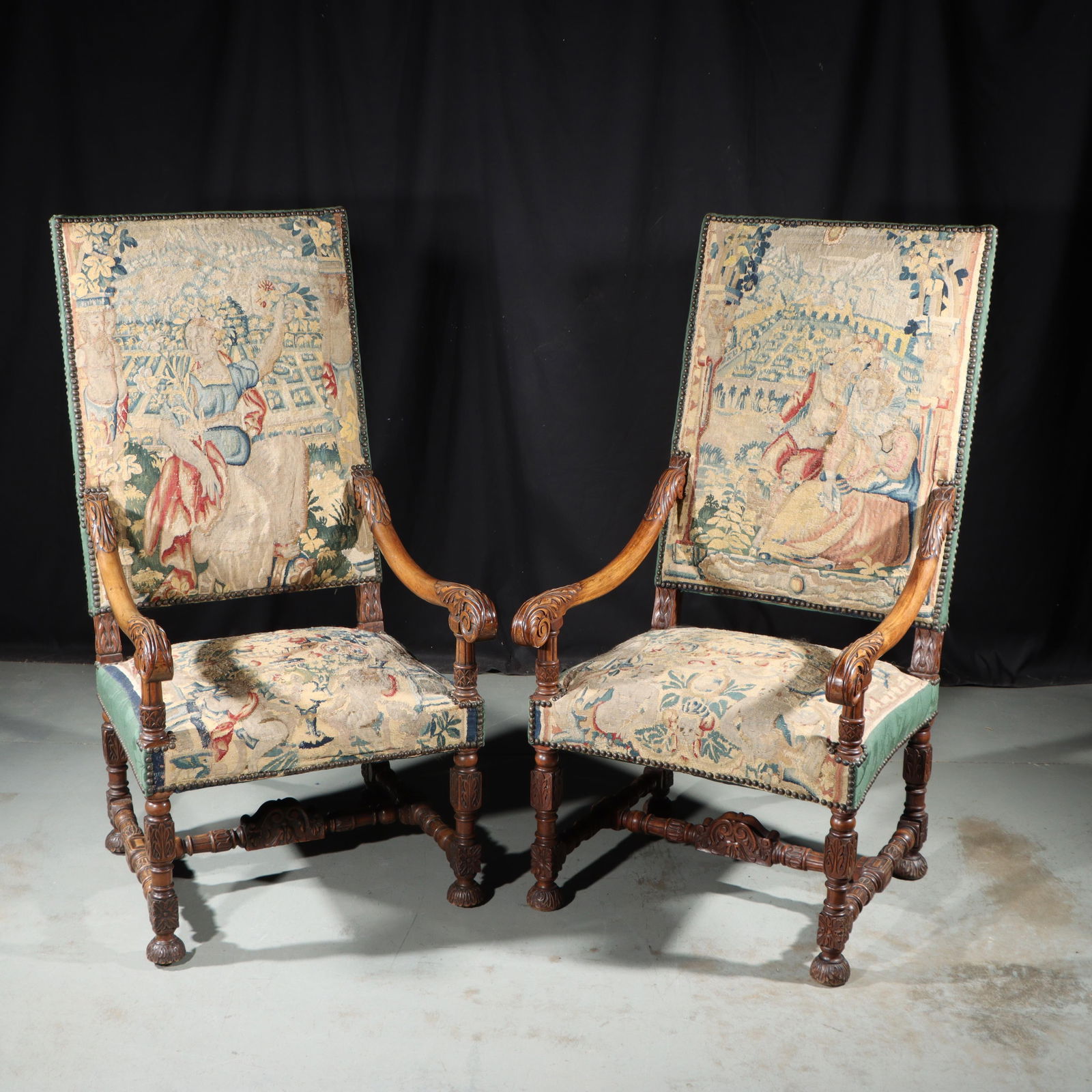Pair Flemish / French Louis XIV style highback walnut armchairs with scenic tapestry upholstery and: Pair Flemish / French Louis XIV style highback walnut armchairs with scenic tapestry upholstery and ornate carving 52"H x 26 1/2"W x 28"D; 18" Seat to floor - one chair measured, same size