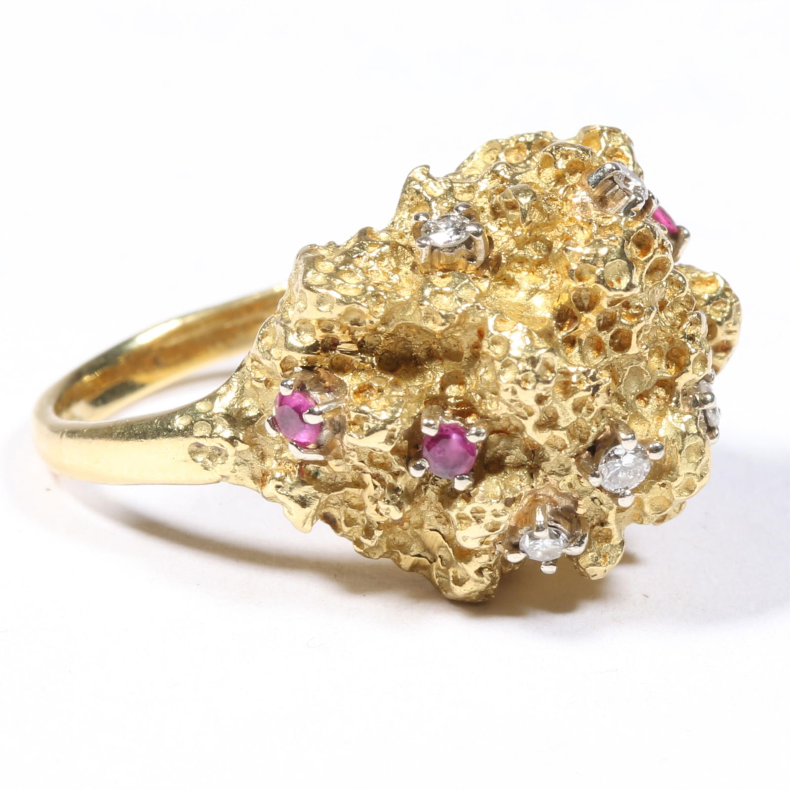 18K gold textured nugget ring decorated with rubies and diamonds. Ring size 6 1/2: 18K gold textured nugget ring decorated with rubies and diamonds. 7.85 dwt 5 rubies 5 diamonds The purchase of gold requires confirmed funds. Ring size 6 1/2