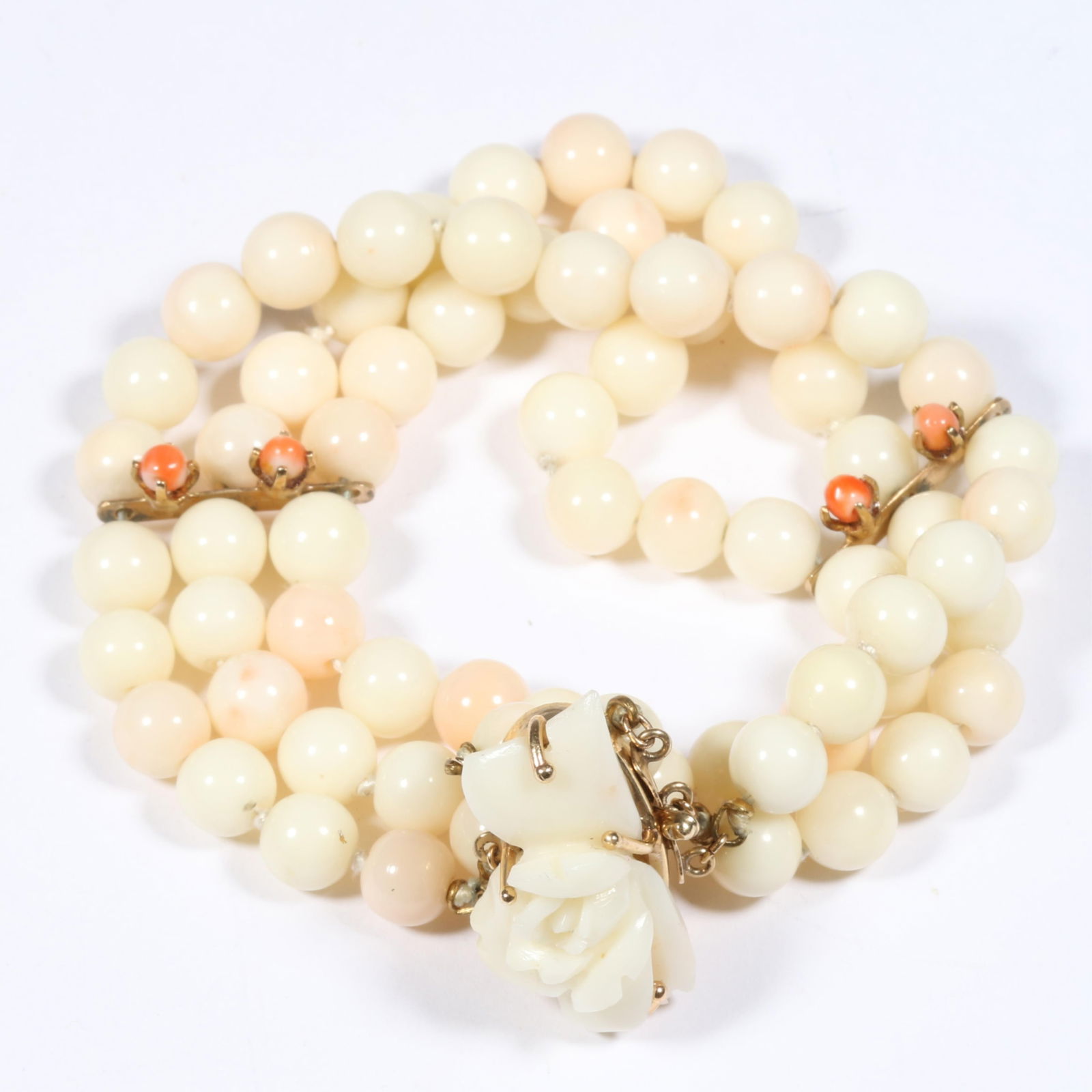 14K gold multistrand knotted angel skin coral bracelet with floral carved clasp and orange coral: 14K gold multistrand knotted angel skin coral bracelet with floral carved clasp and orange coral accents 24.60 dwt The purchase of gold requires confirmed funds. 7 1/4"L x 1 1/2"W