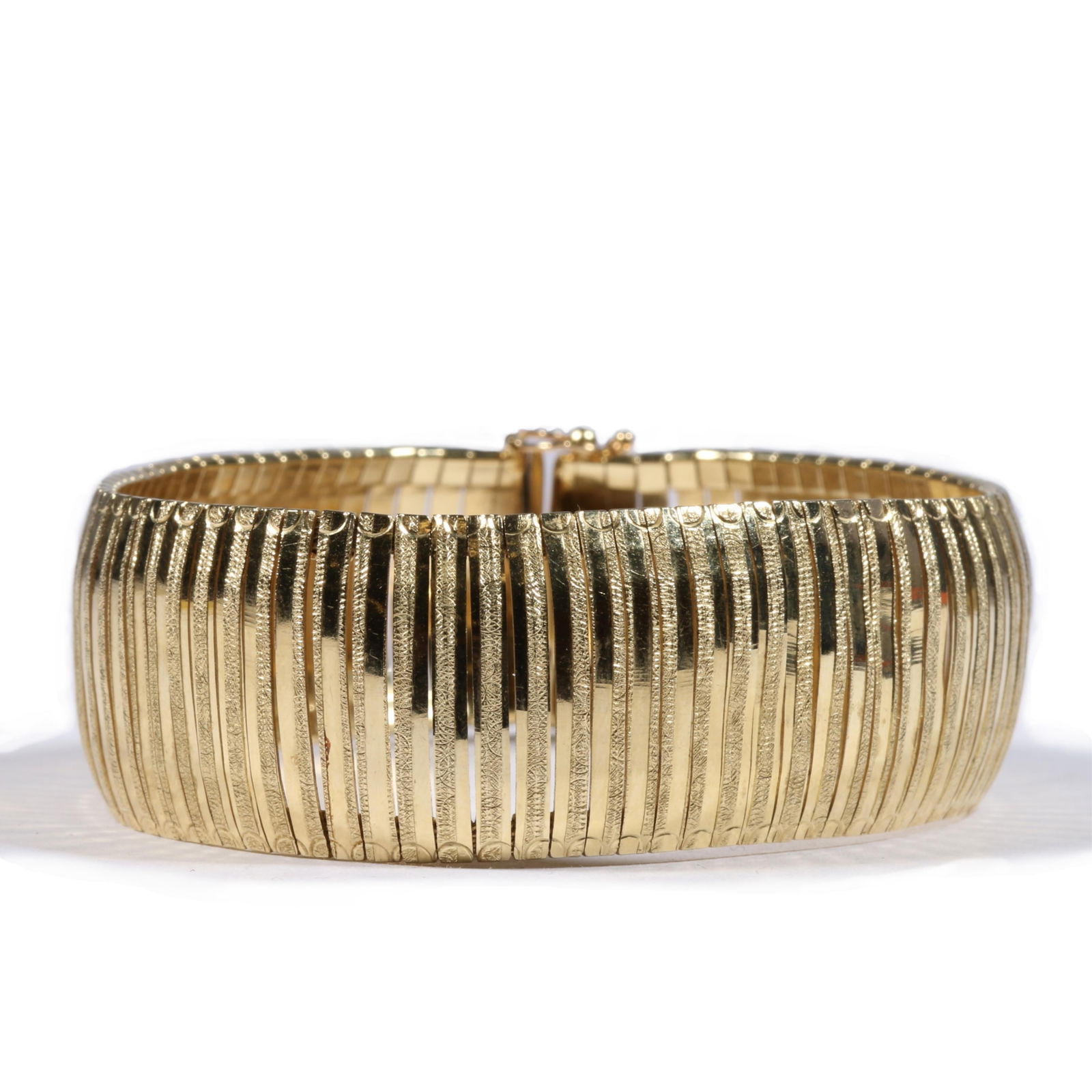 14K yellow gold Italian flexible link bracelet. 7 1/4"L x 7/8"W: 14K yellow gold Italian flexible link bracelet. A few kinks or bent gold strips, clasp is loose but does have a secure snap safety mechanism. 19.04DWT The purchase of gold requires confirmed funds. 7