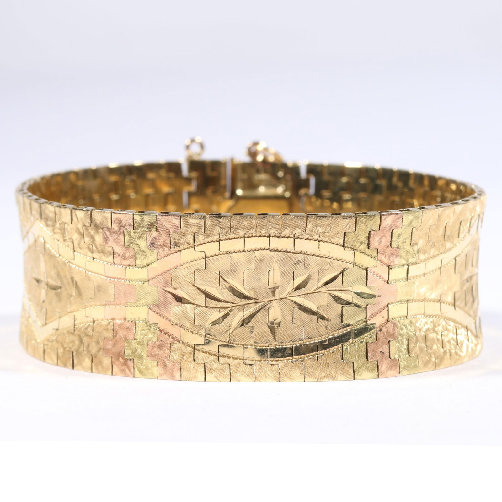 18K ItalMex tri color gold engraved articulated bracelet. 7 3/8"L x 1"W: 18K ItalMex tri color gold engraved articulated bracelet. 37.7DWT The purchase of gold requires confirmed funds. 7 3/8"L x 1"W