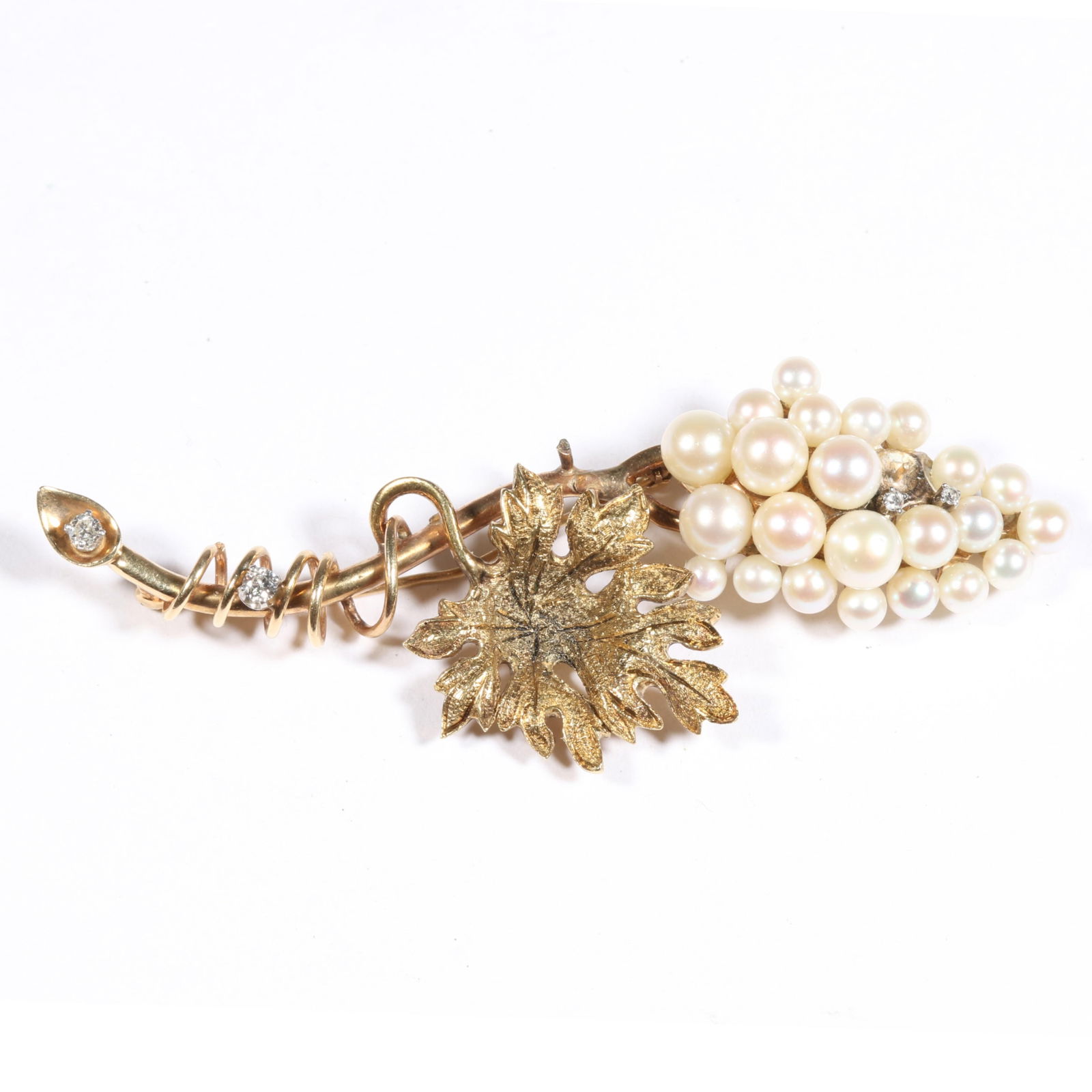 14K yellow gold grape vine brooch with pearl grapes, textured leaf, and diamond accents. 3"L x 1: 14K yellow gold grape vine brooch with pearl grapes, textured leaf, and diamond accents. One missing pearl, possible missing leafs details (photos shown at the end). 10.077DWT The purchase of gold req