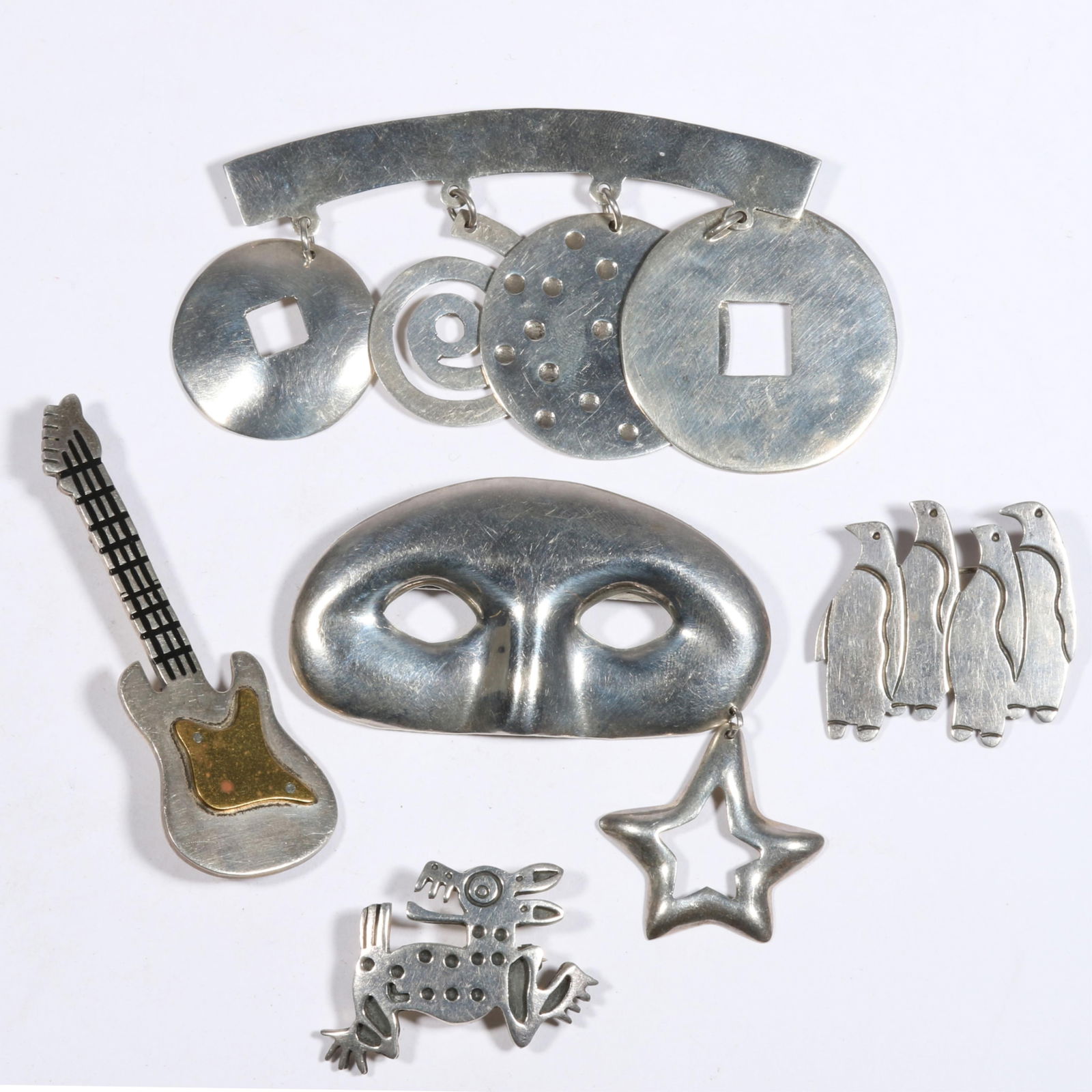 Mexican sterling silver 5pc brooch group. 2 5/8"L x 2 1/2"W (mask brooch): Mexican sterling silver 5pc brooch group. 87.8 grams total From the life time collection of Donna Soodalter-Toman, DIVA owner/founder and winner of Best of Boston for DIVA's prominent role in the jewe