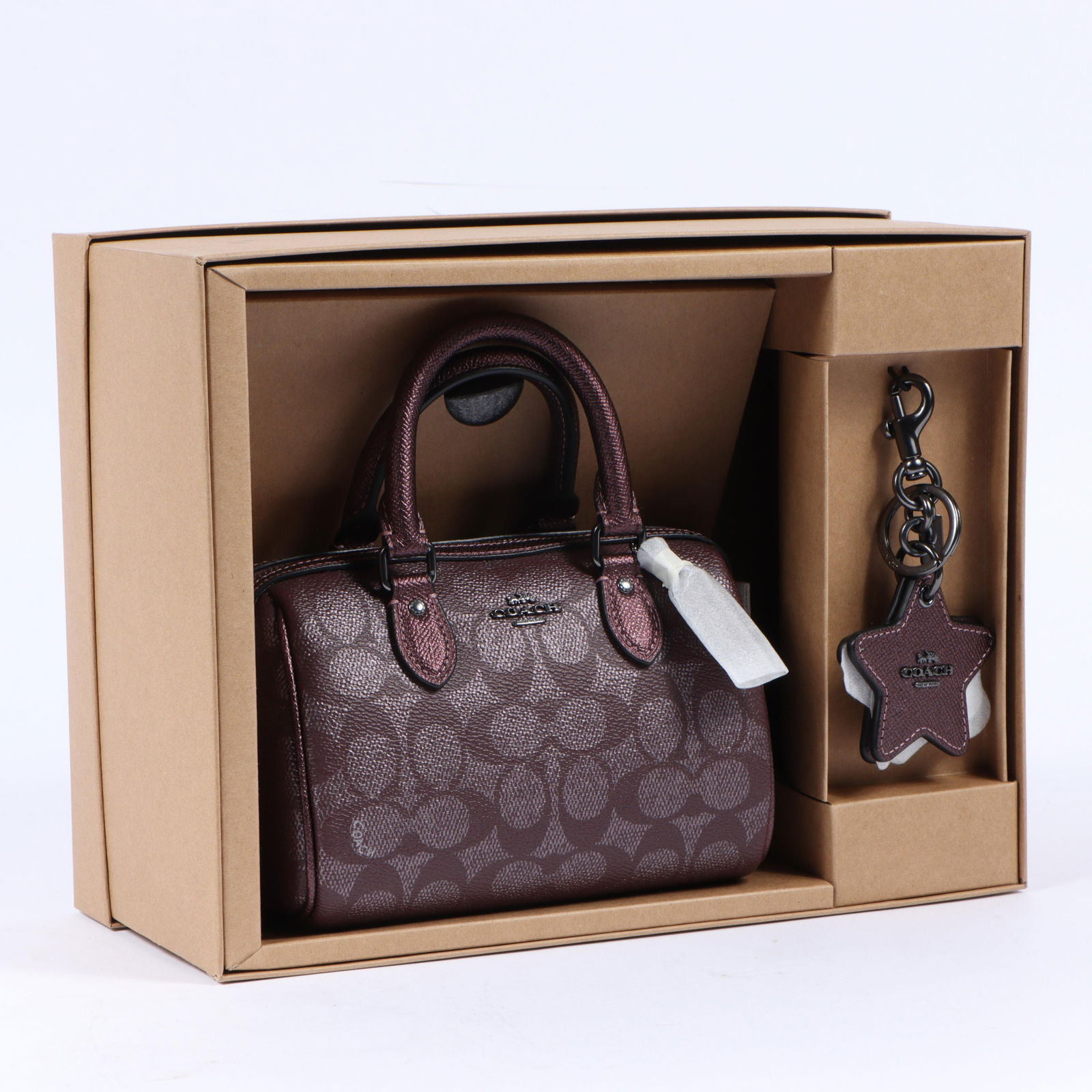 Coach Mini Rowan crossbody bag and keychain mirror, in original gift box 5 1/2"H x 12 1/4"W x 9: Coach Mini Rowan crossbody bag and keychain mirror, in original gift box 5 1/2"H x 12 1/4"W x 9 1/4"D (box); 5 1/4"H x 7 1/2"W x 3 1/2"Drop (bag)