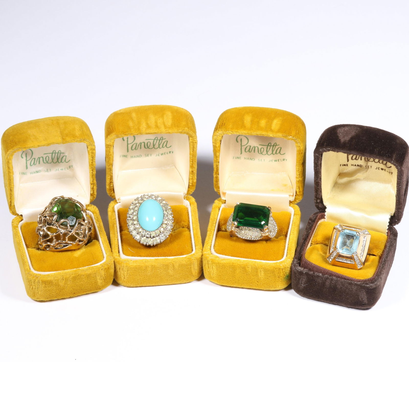 4pc group of vintage 1960's Panetta cocktail rings in original boxes Ring size 6 (light blue stone: 4pc group of vintage 1960's Panetta cocktail rings in original boxes Emerald green stone and retro blue translucent stone ring have sterling shank. Some residue to all. Ring size 6 (light blue stone f