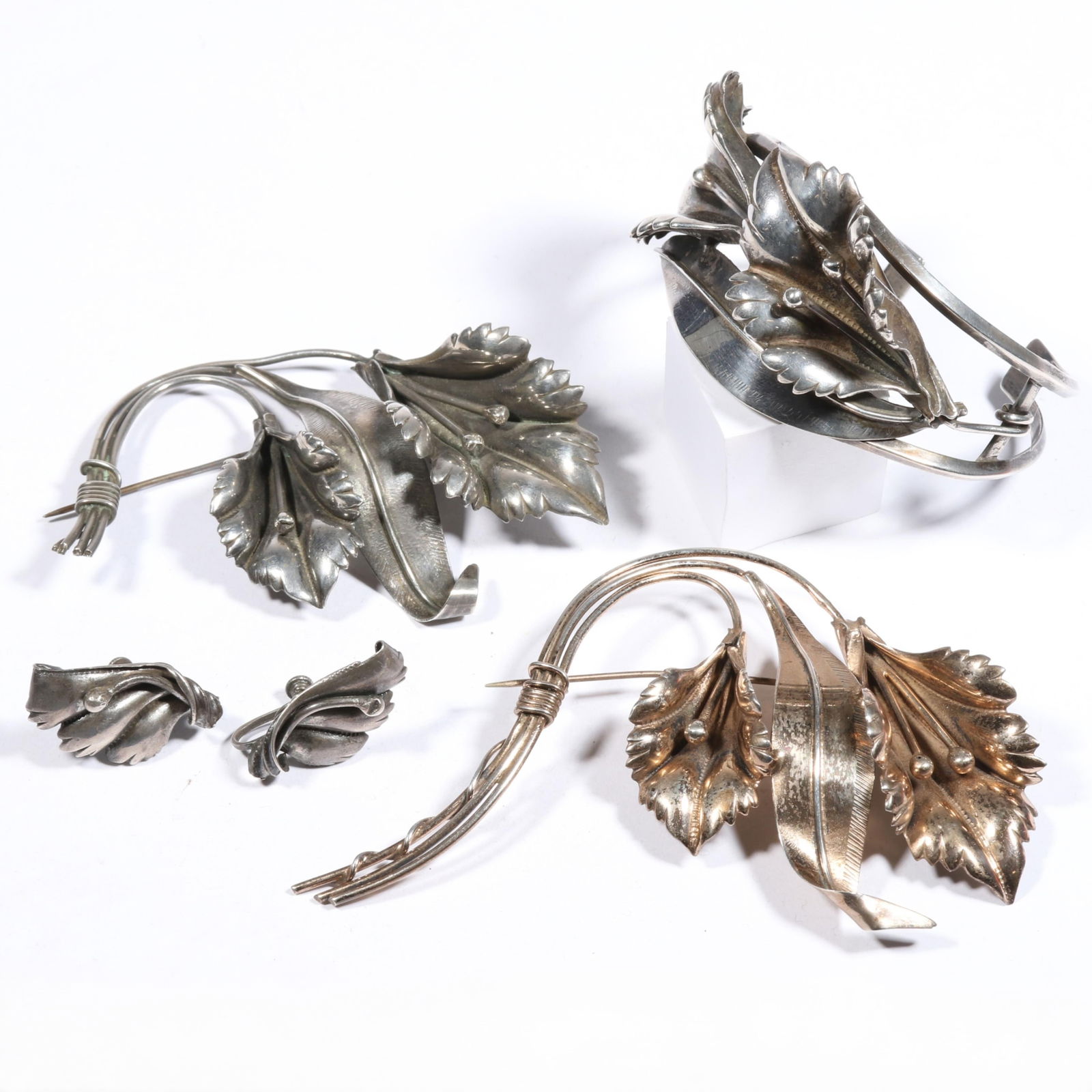 Sterling and sterling vermeil floral jewelry group including bracelet, brooches and earrings. 1: Sterling and sterling vermeil floral jewelry group including bracelet, brooches and earrings. 86.6 grams total From the life time collection of Donna Soodalter-Toman, DIVA owner/founder and winner of