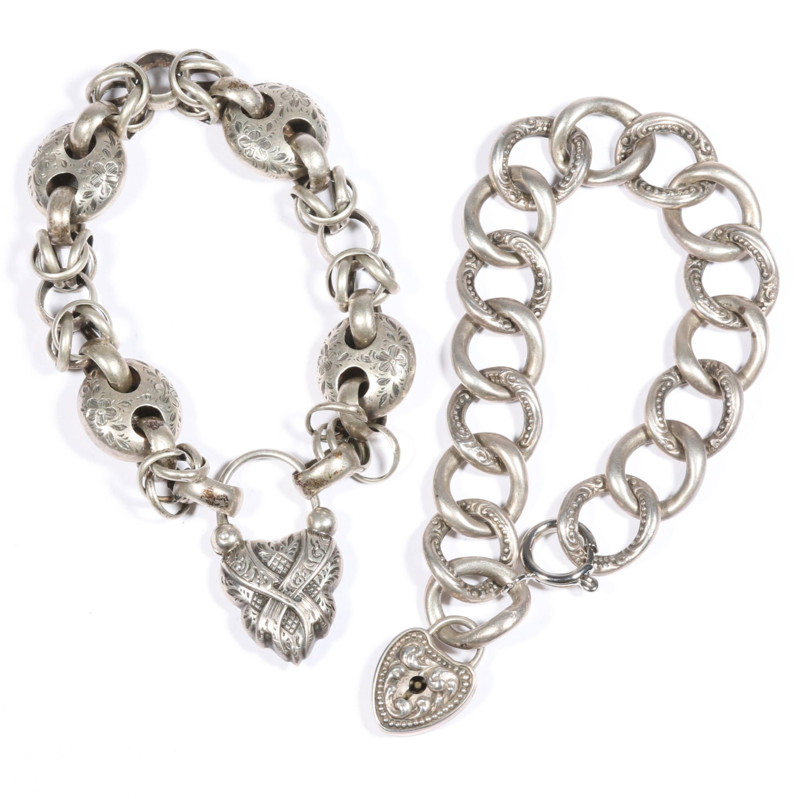 Pair of antique Victorian silver embossed link heart and lock bracelets, one marked sterling 7"L x: Pair of antique Victorian silver embossed link heart and lock bracelets, one marked sterling Some links have dents, one with replaced non sterling clasp. Provenance: From the collection of Sue Rudman,