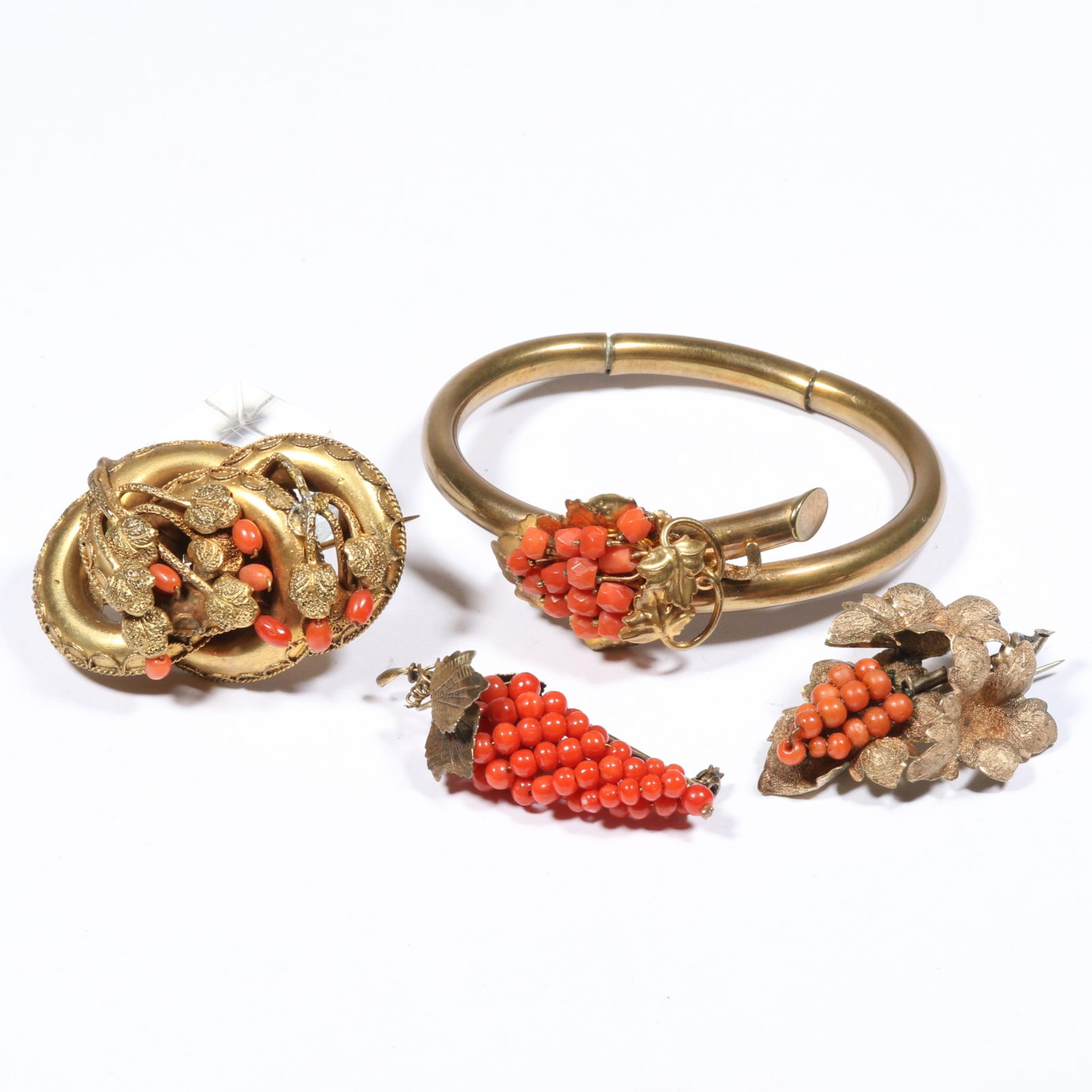 Victorian gold filled coral "grapes" group with hinged bangle bracelet and 3 brooches 1"H x 2: Victorian gold filled coral "grapes" group with hinged bangle bracelet and 3 brooches Some wear to gold fill, bracelet's hinges are slightly worn out, one brooch has some repair solder to the back. Pr