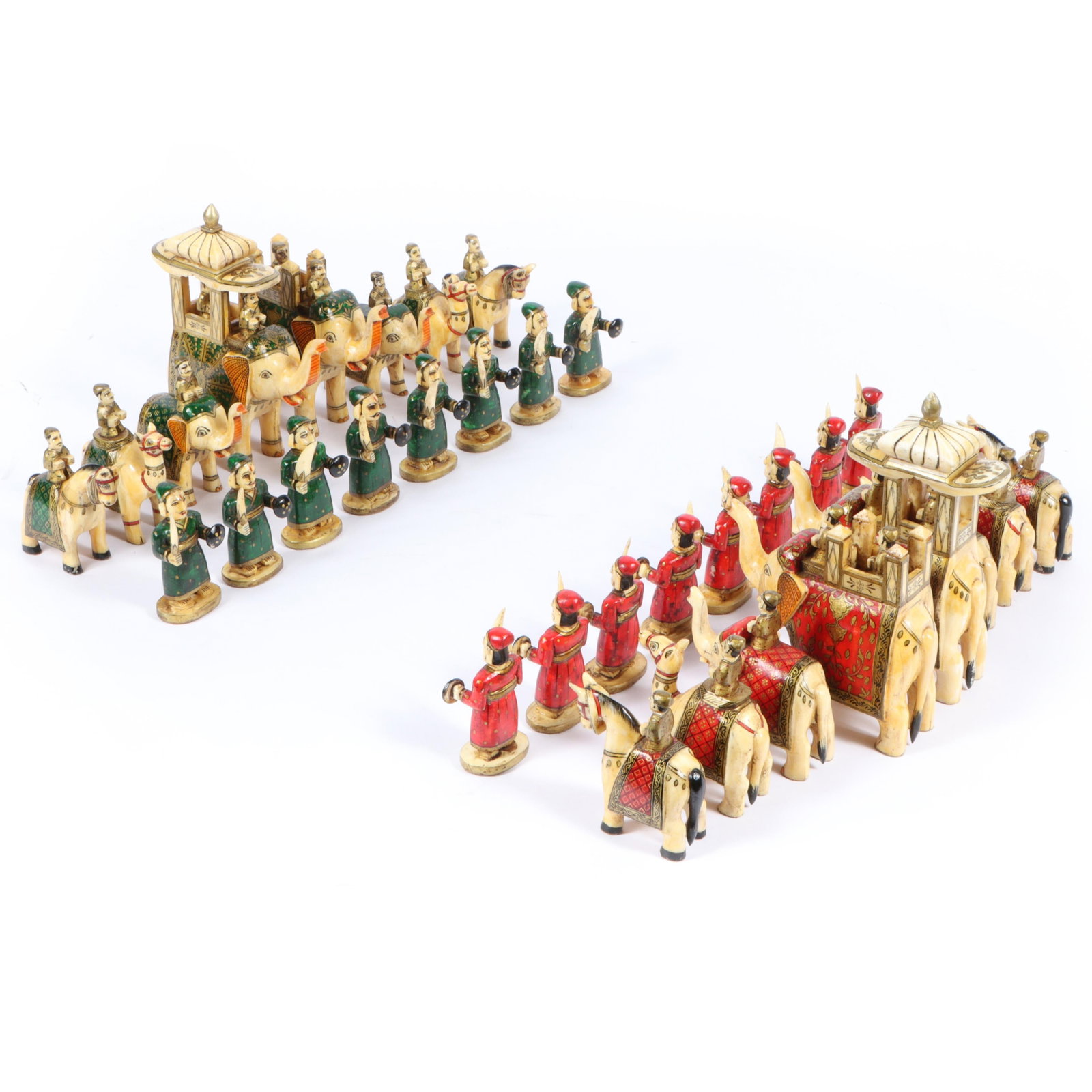 Indian camel bone chess set, carved and painted 32 piece set depicting two Rajasthani armies in: Indian camel bone chess set, carved and painted 32 piece set depicting two Rajasthani armies in shades of red and green representing two armies of Rajasthan in red and green colors; the pawns are carv