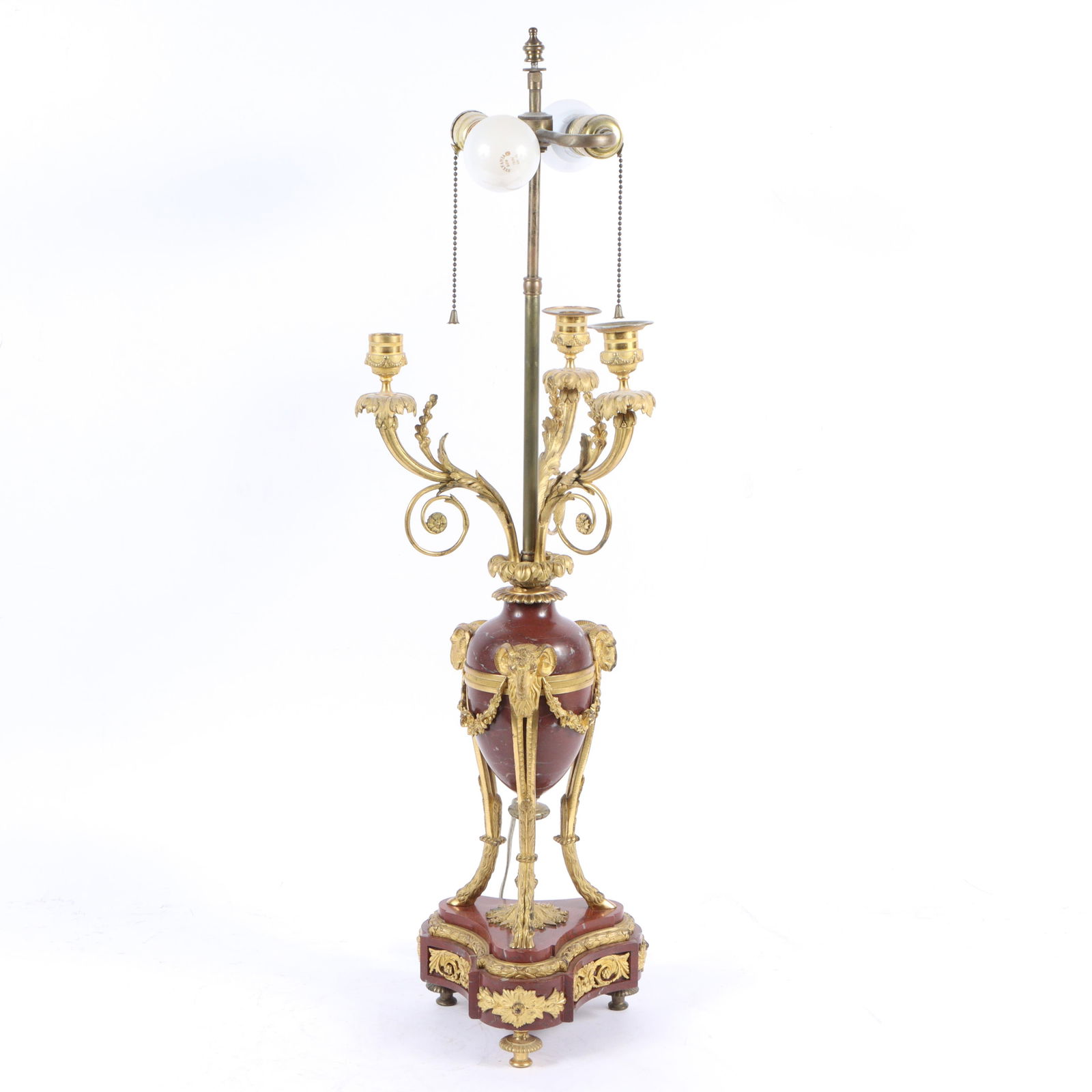 French Empire Napoleon III rouge marble and gilt dore bronze urn lamp conversion with ram head and: French Empire Napoleon III rouge marble and gilt dore bronze urn lamp conversion with ram head and cloven foot accents with floral swag and scrolling foliate detail. 33 1/2"H x 10"W (without lampshade
