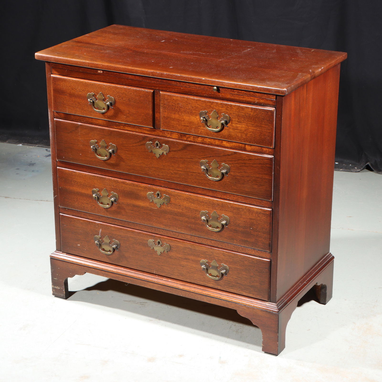 Georgian mahogany bachelor's chest of drawers with leather inlaid brushing slide, 30"H x 30"W x 16"D: Georgian mahogany bachelor's chest of drawers with leather inlaid brushing slide, 4 drawers, and brass hardware. Maddox, Jamestown, NY label. 30"H x 30"W x 16"D