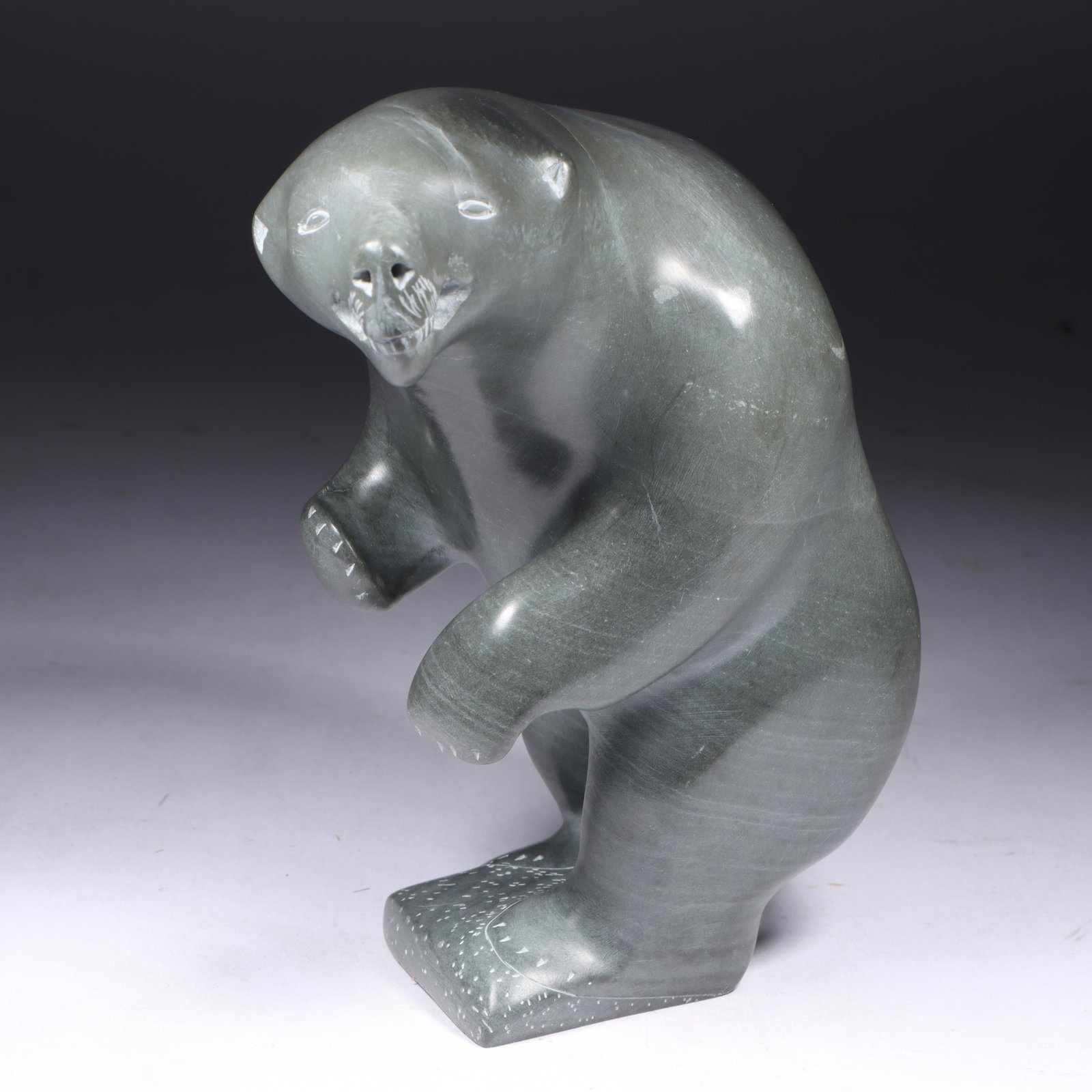 Inuit indigenous carved soapstone polar bear sculpture: Canada label, and incised signature. 7"H x: Inuit indigenous carved soapstone polar bear sculpture: Canada label, and incised signature. 7"H x 4"W