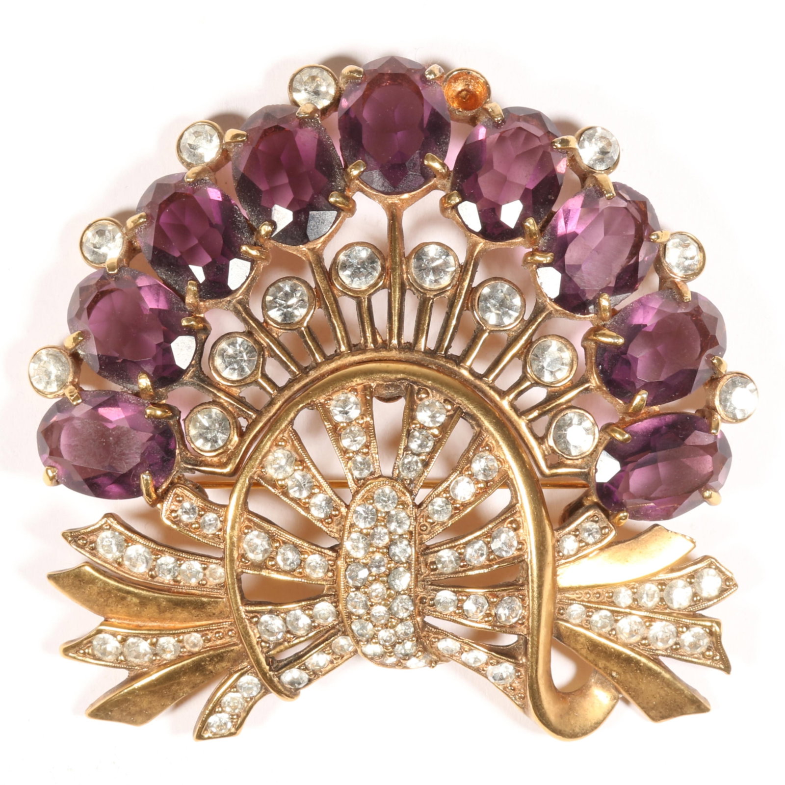 Eisenberg Original brooch in antiqued gold pot metal with 9 amethyst crystals with half circle of: Eisenberg Original brooch in antiqued gold pot metal with 9 amethyst crystals with half circle of pave and bezel-set stones Missing one rhinestone Page 51, figure 2.66 from "Eisenberg Originals, The G
