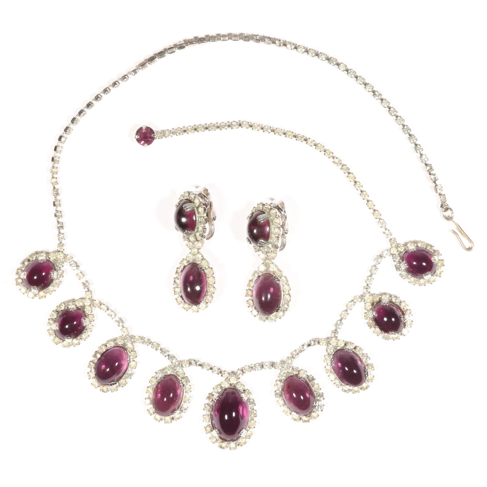 Vintage Crown Trifari demi parure with smoky amethyst purple glass cabochons surrounded by diamante: Vintage Crown Trifari demi parure with smoky amethyst purple glass cabochons surrounded by diamante rhinestones, necklace and earrings Necklace has possible replaced clasp and is unsigned 18"L x 1 1/8