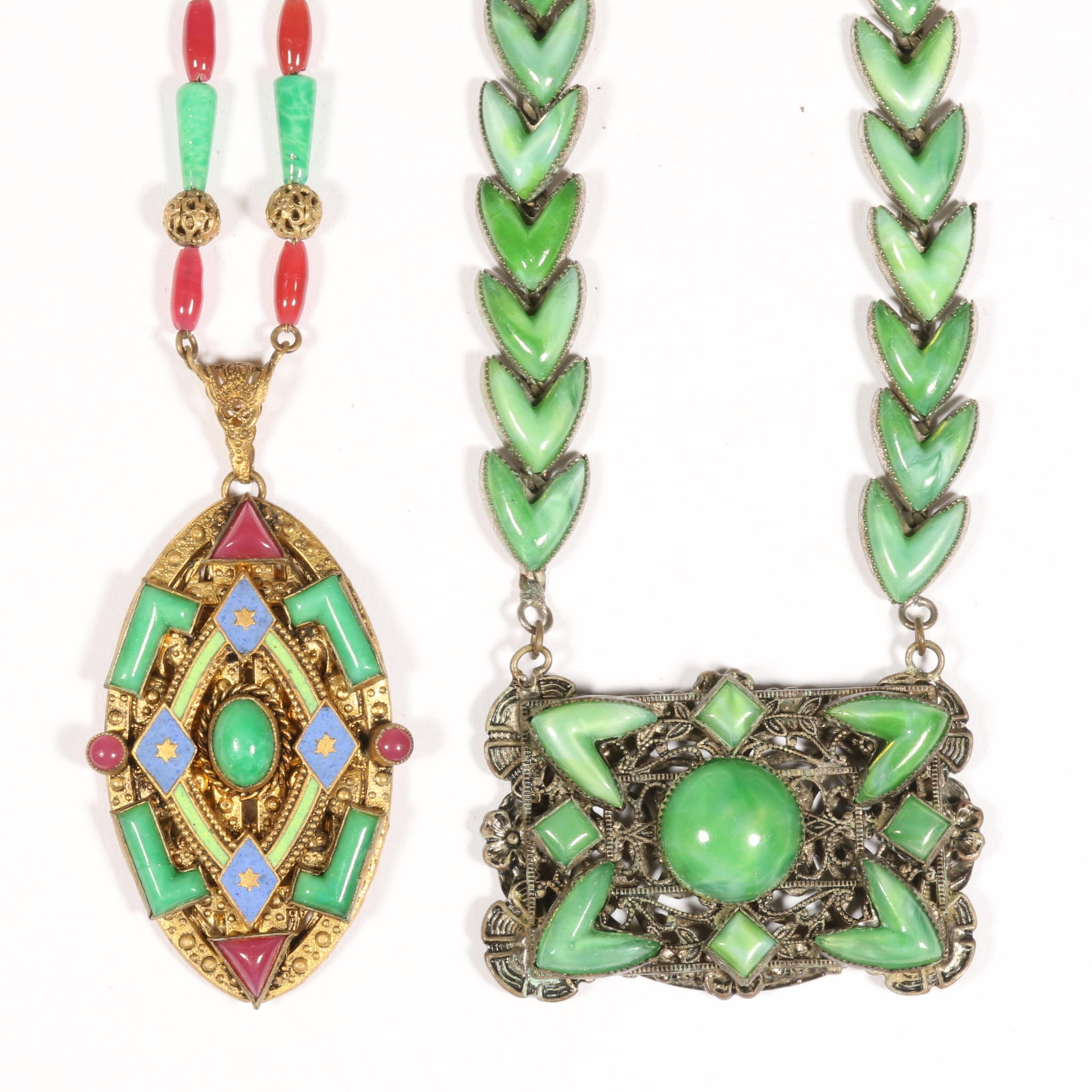Pair of Czech glass pendant necklaces, one with enamel detail 16"L x 1 1/4"Drop (all green): Pair of Czech glass pendant necklaces, one with enamel detail Longer of the two is signed Czechoslovakia on the clasp Provenance: From the Collection of Joan Duran 16"L x 1 1/4"Drop (all green)