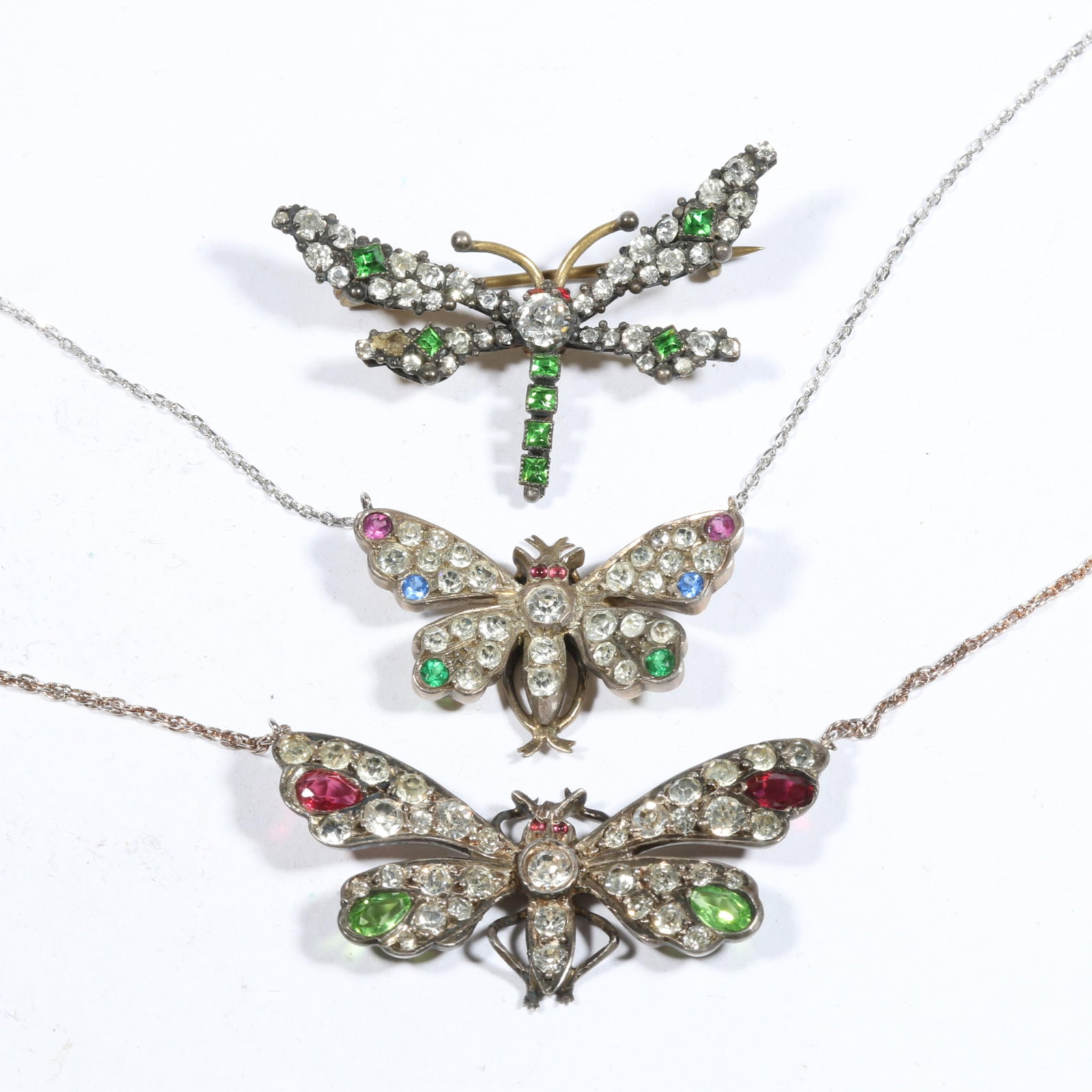 Antique sterling paste stone converted butterfly necklaces and dragonfly brooch. 18 1/2"L x 1"W: Antique sterling paste stone converted butterfly necklaces and dragonfly brooch. Provenance: From the collection of Sue Rudman, owner of Antique Source, Ltd in NYC for more than 45 years. 18 1/2"L x 1