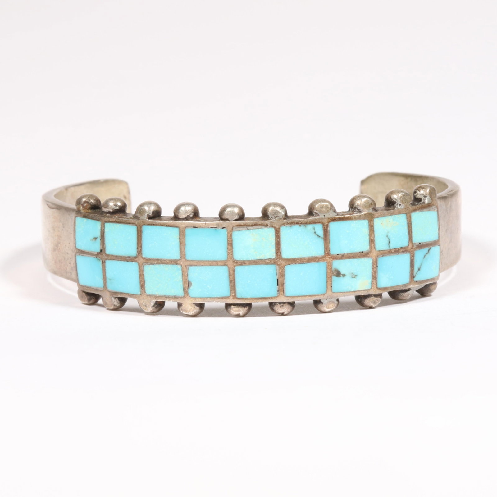 Native American unmarked sterling cuff bracelet featuring a turquoise channel inlay design 5/8"H x 2: Native American unmarked sterling cuff bracelet featuring a turquoise channel inlay design 42.9 grams 5/8"H x 2 1/2"Diam.