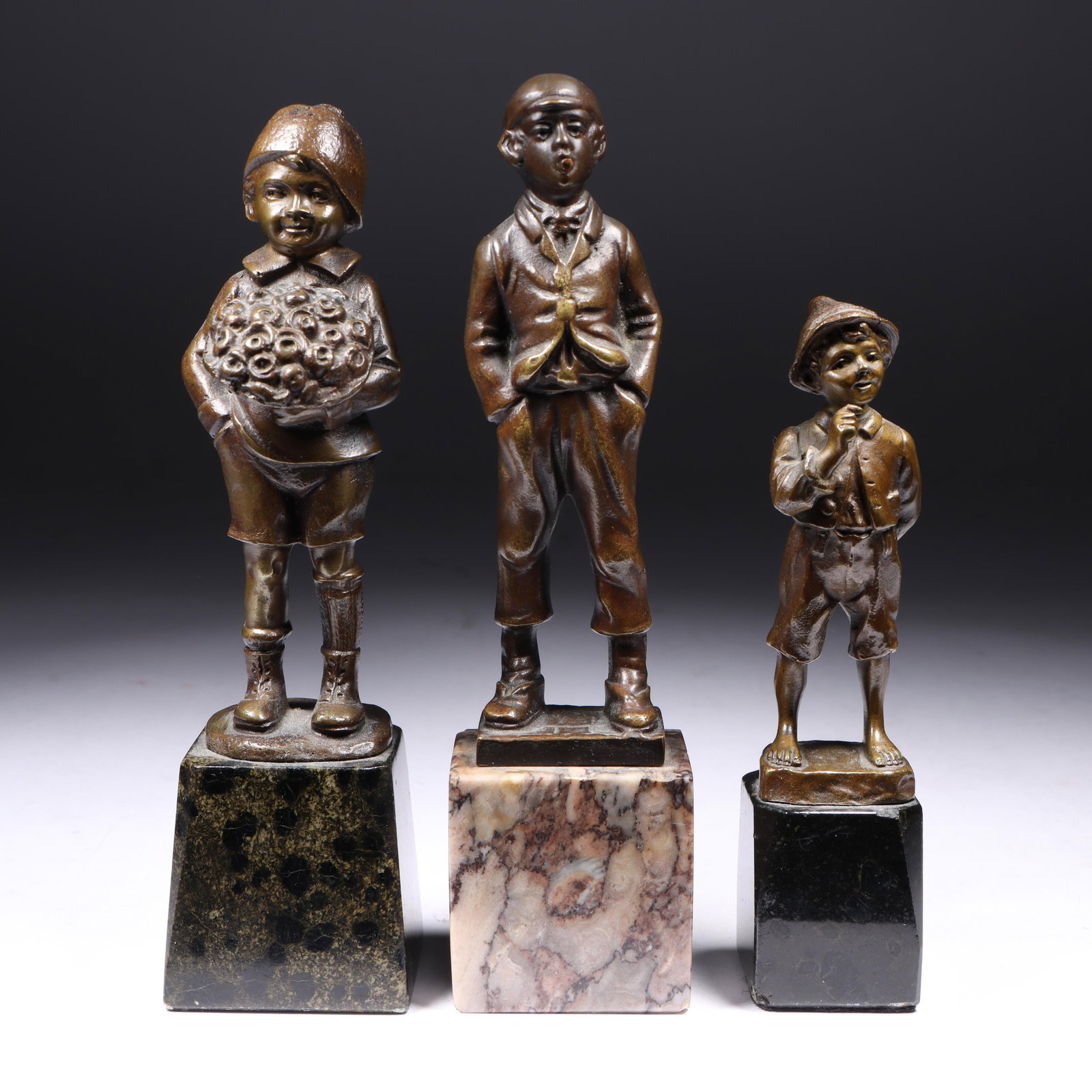 Three bronze boy figural cabinet sculptures on marble bases; smoking, holding flowers, and hands in (1 of 10)
