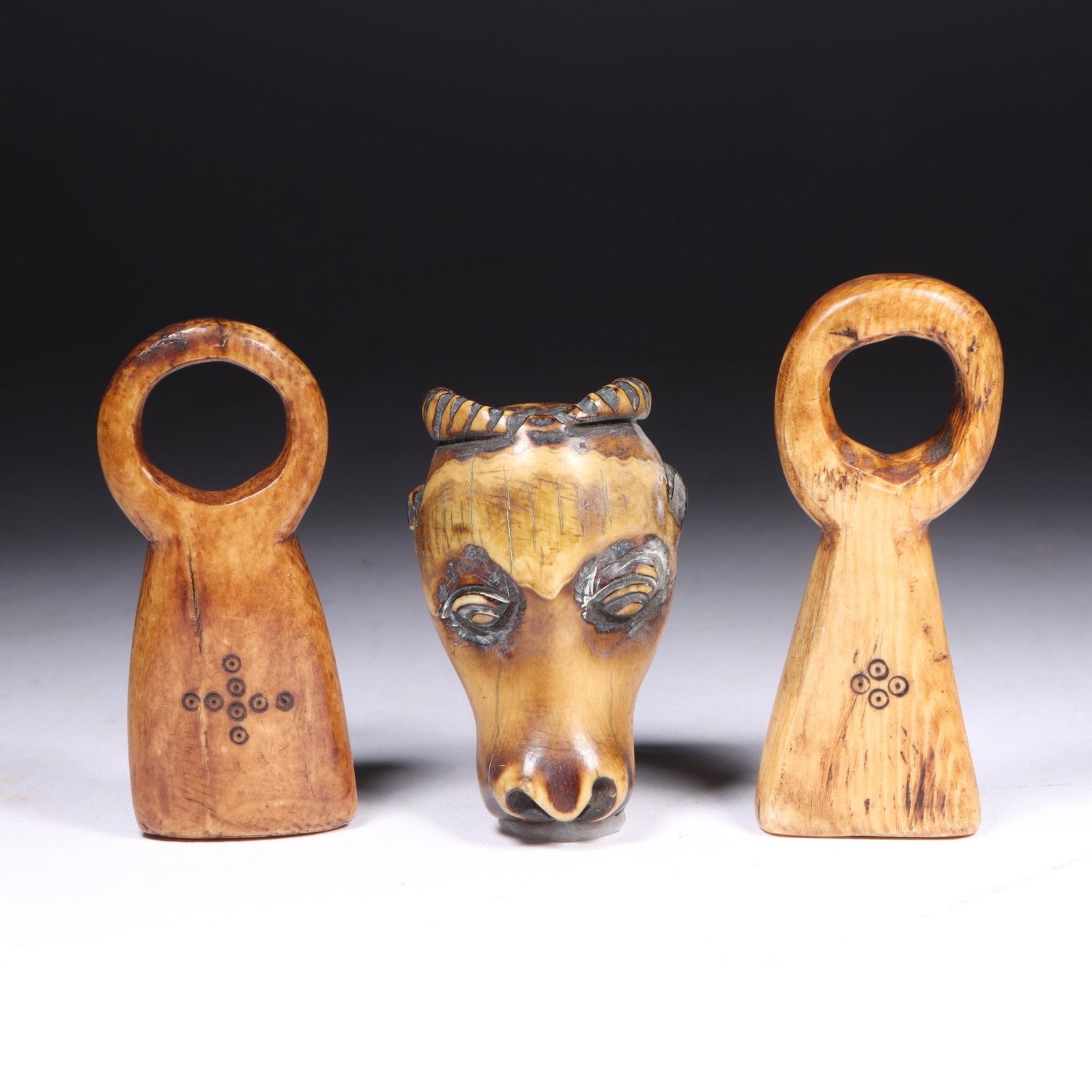 Three African tribal bone carvings, bull mask and amulet? pendants. 3"H x 1 1/4"W (one item (1 of 9)