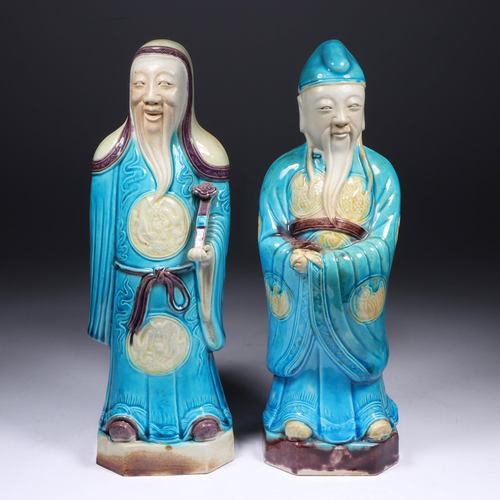 Pair of Chinese turquoise glazed ceramic Taoist Immortal Figures with symbols on their robes. 10 (1 of 17)